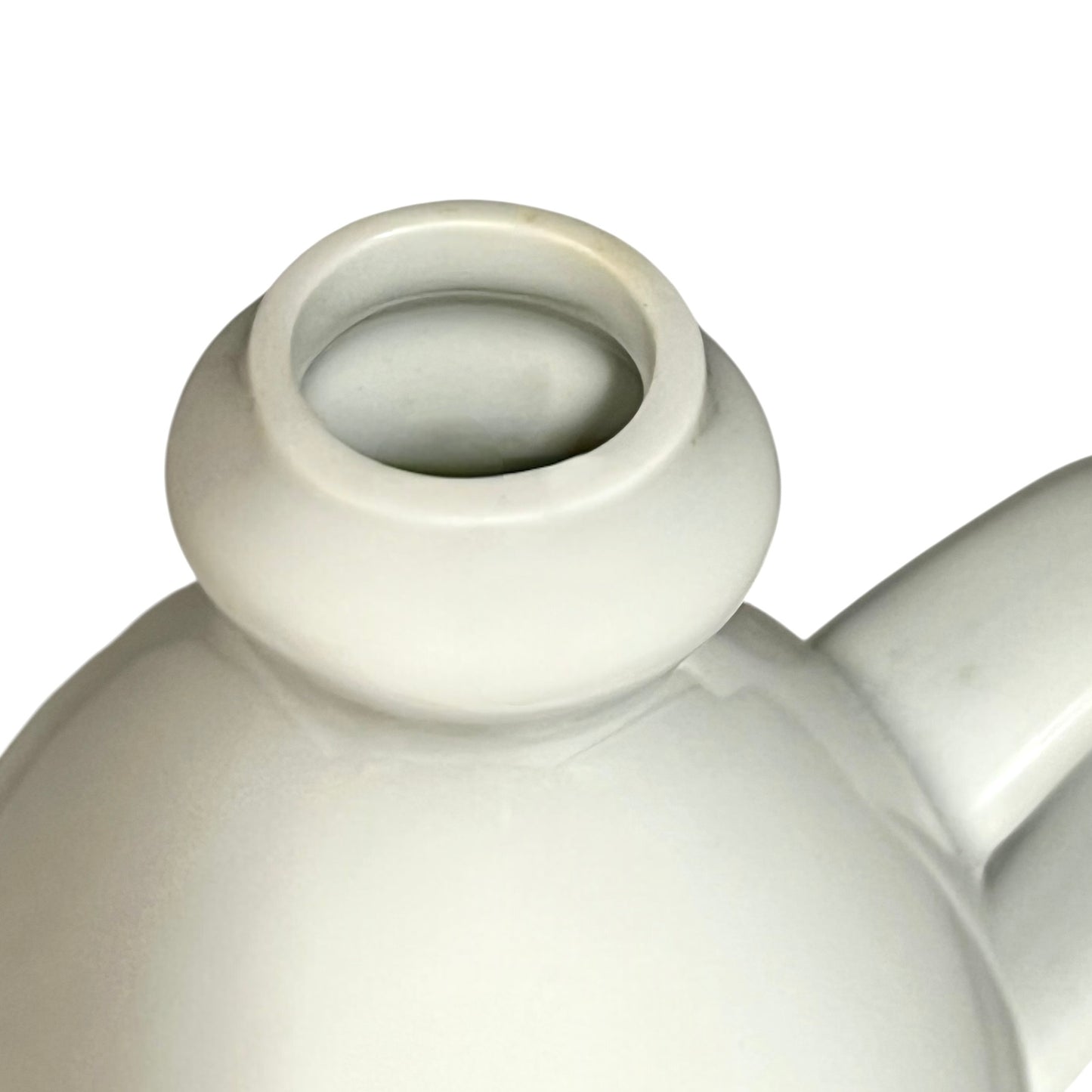 Close-up of a white ceramic teapot on a white background