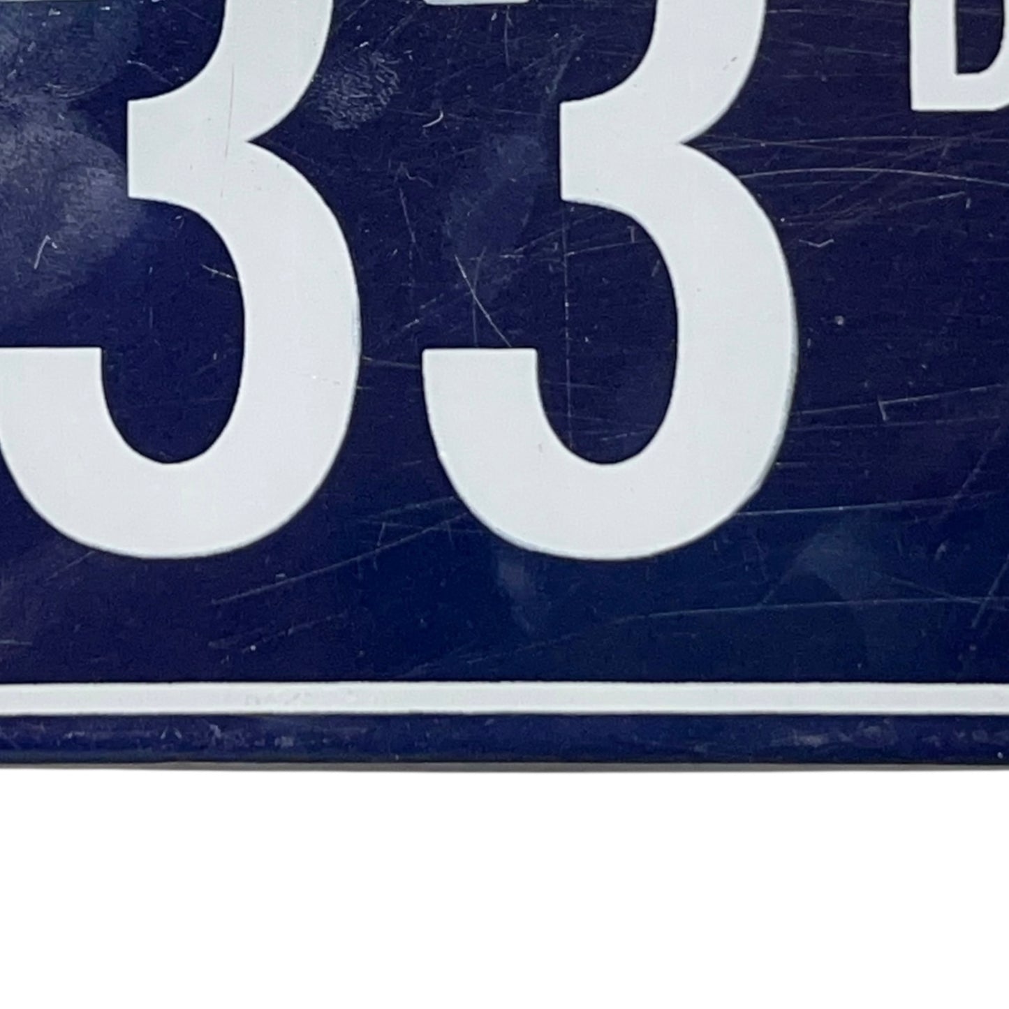Close-up of a number '33' on a textured blue background