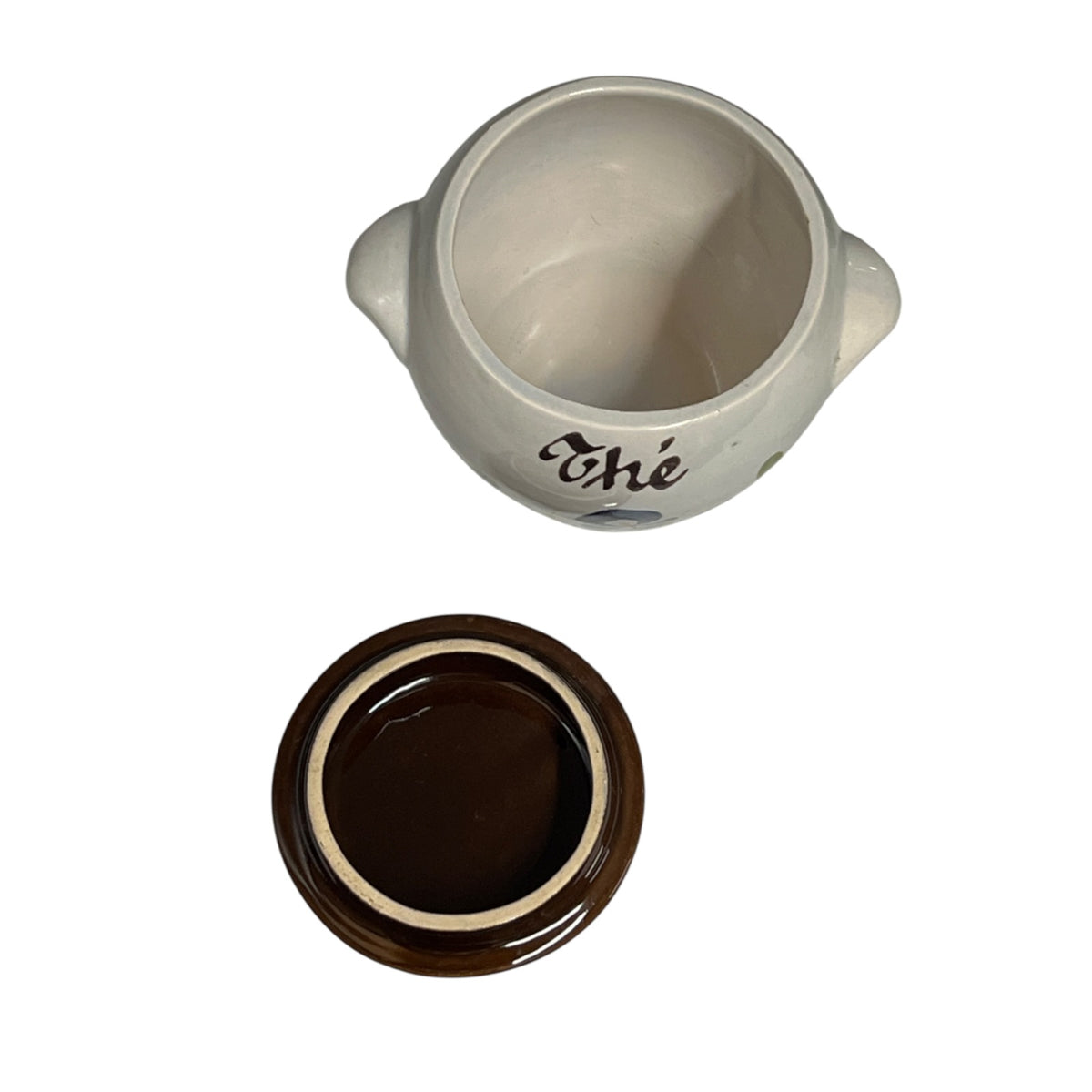 A ceramic jar with a matching lid, shown on a plain white background. The mug is off-white with a dark brown script word 'Chic' printed on the side, and the lid below it is dark brown with a cream-coloured rim.