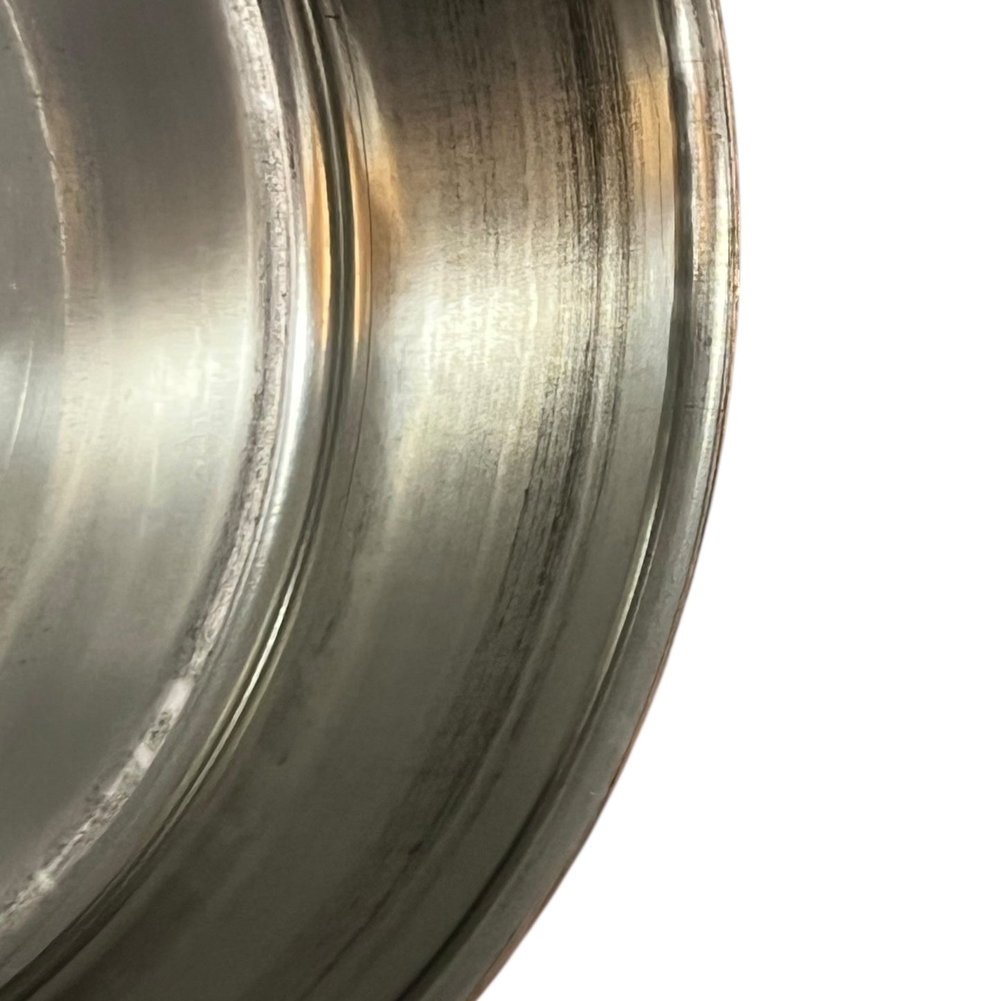 inside of copper pan with tin lining on a white background