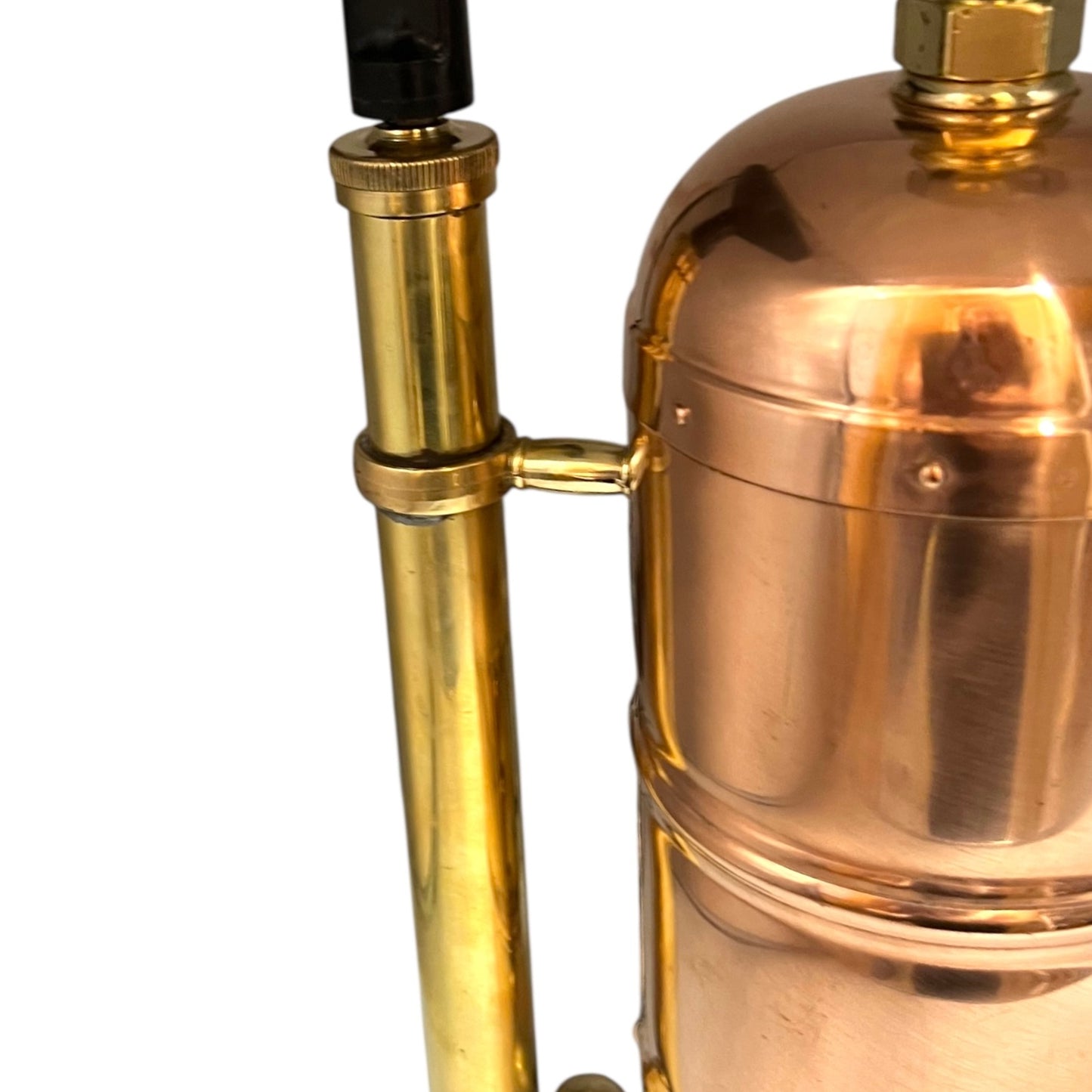 Close-up of a brass and copper lamp on a white background