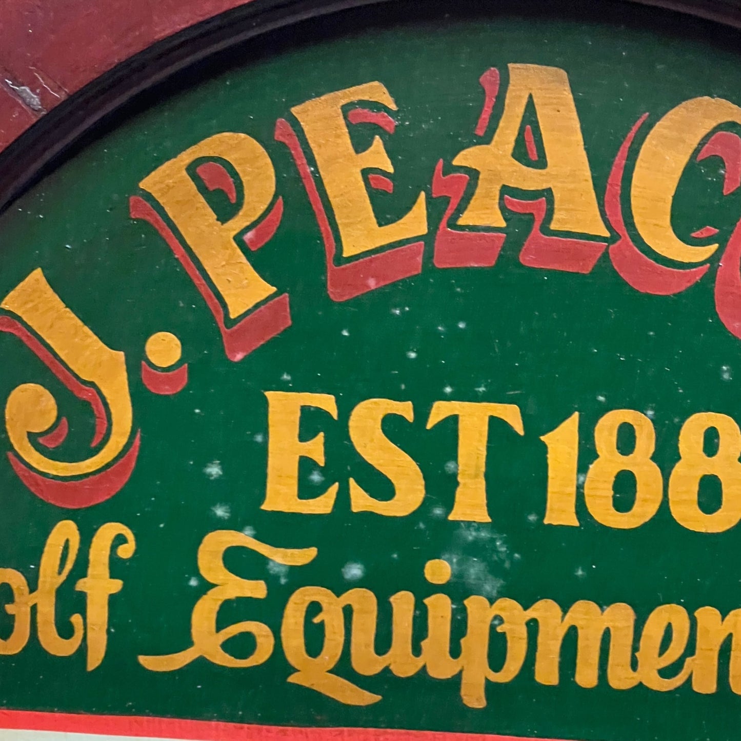 Close-up of a vintage golf sign with 'Equipment' text on a green background