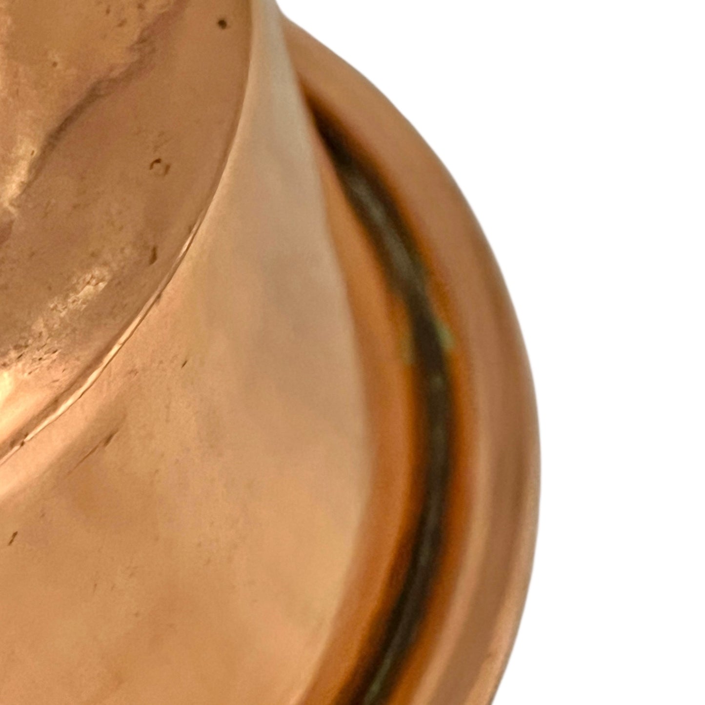 Close-up of a copper pan with a black handle on a white background