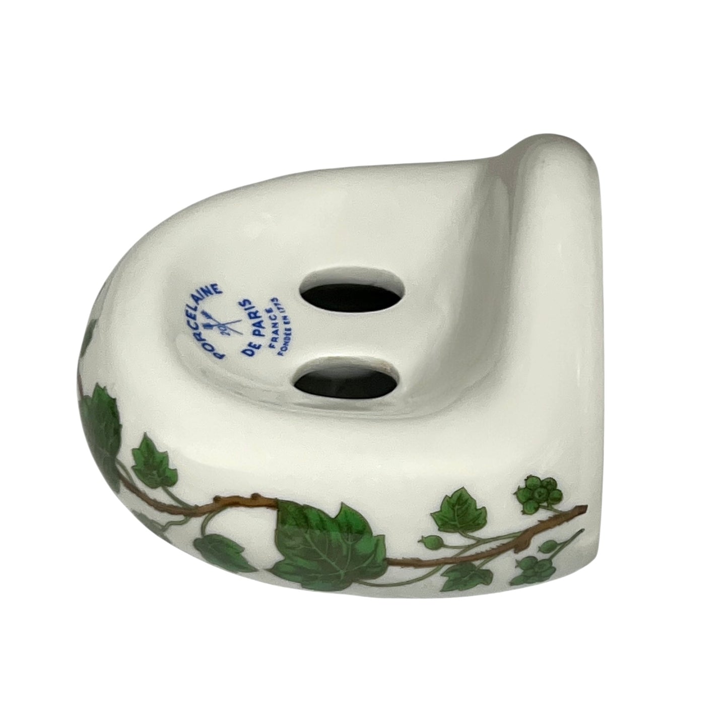 Porcelain bathroom toothbrush holder featuring green leaf patterns on a white background