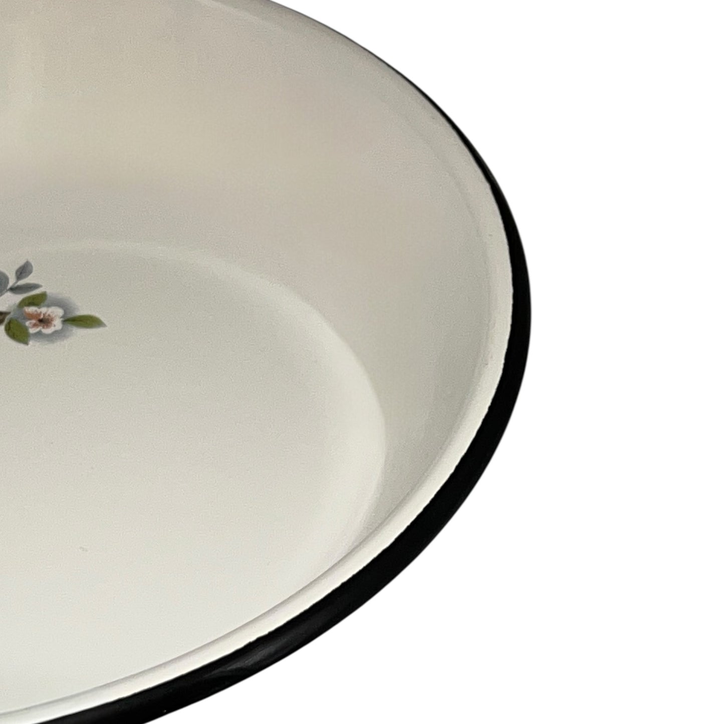 Close-up of a frying pan with floral design on a white background