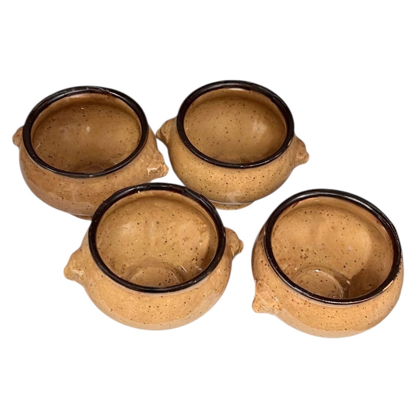 Set of four speckled beige lions head soup bowls with dark rims on a white background