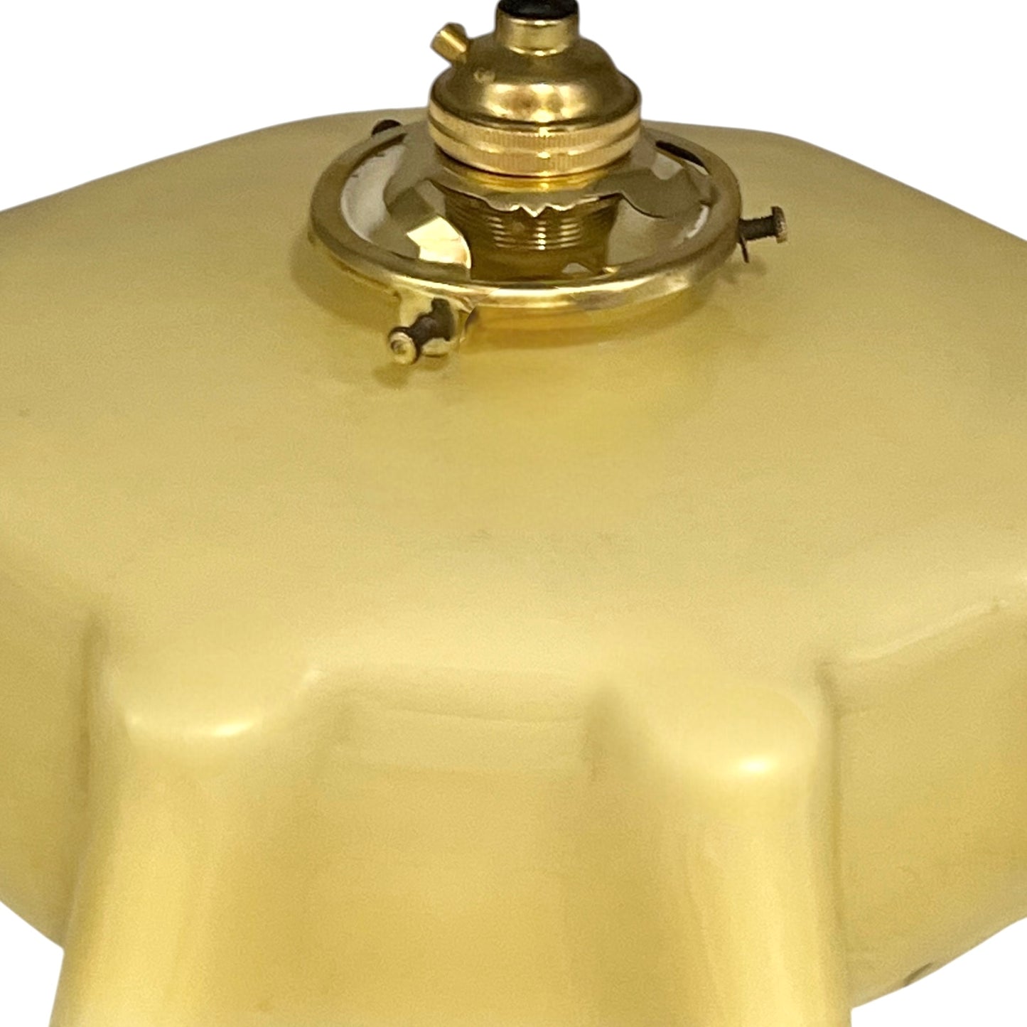 Vintage-style pendant light with a yellow glass shade and brass fitting on a white background