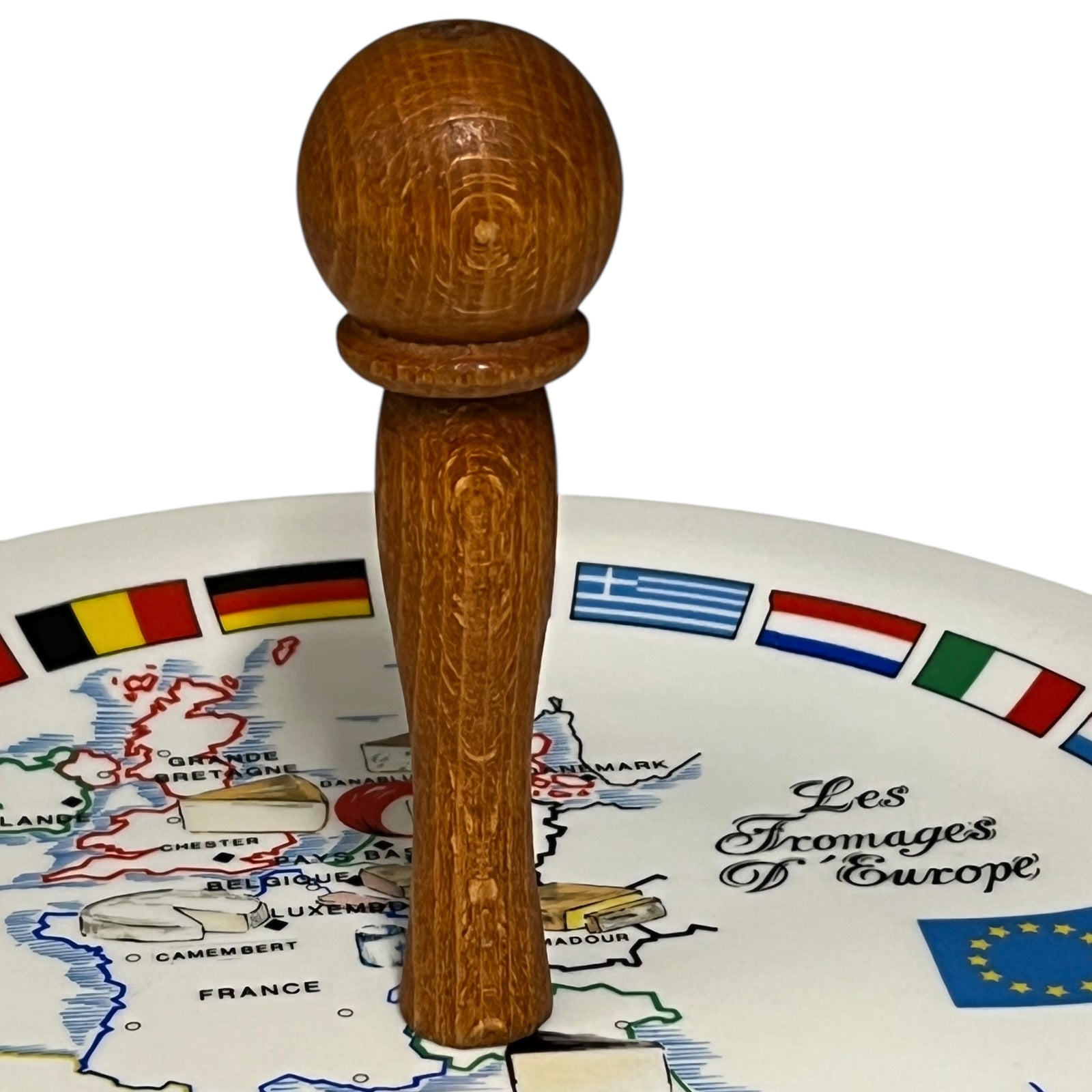 Wooden cheese plate with a map of Europe and cheese types on a white background