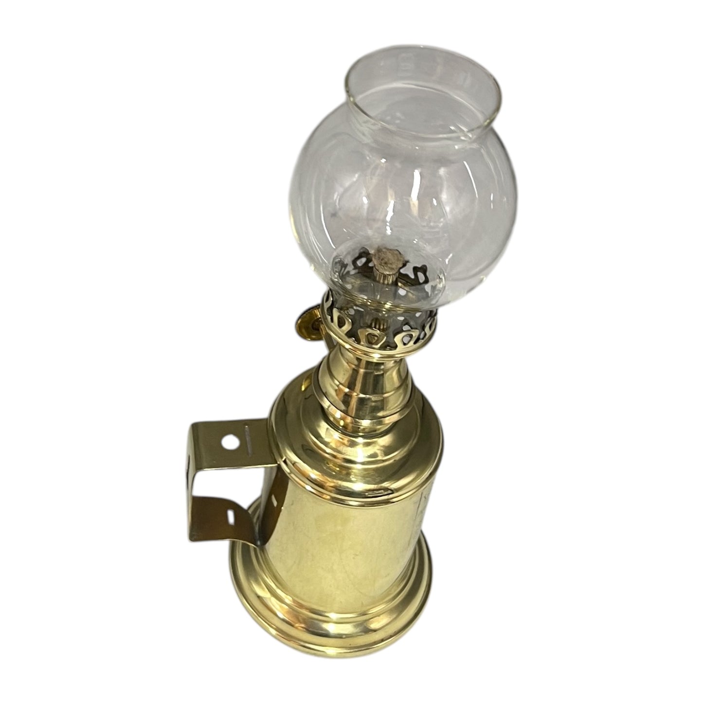 Brass oil lamp with clear glass chimney on a white background