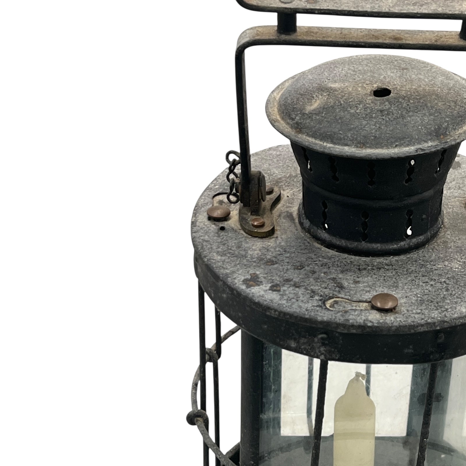 Vintage lantern with metal and glass components on a white background