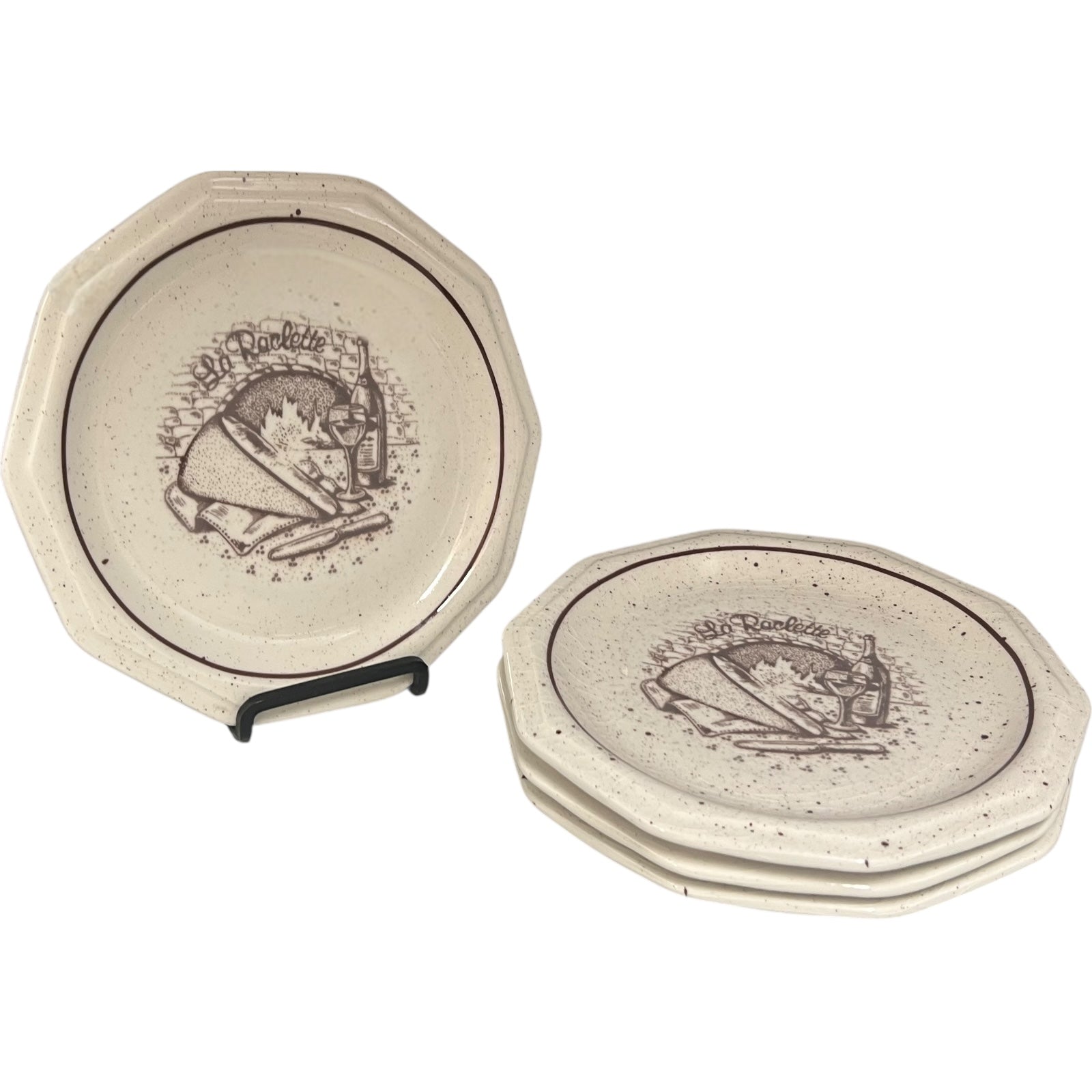 Set of 4 La Raclette plates with a decorative design on a white background