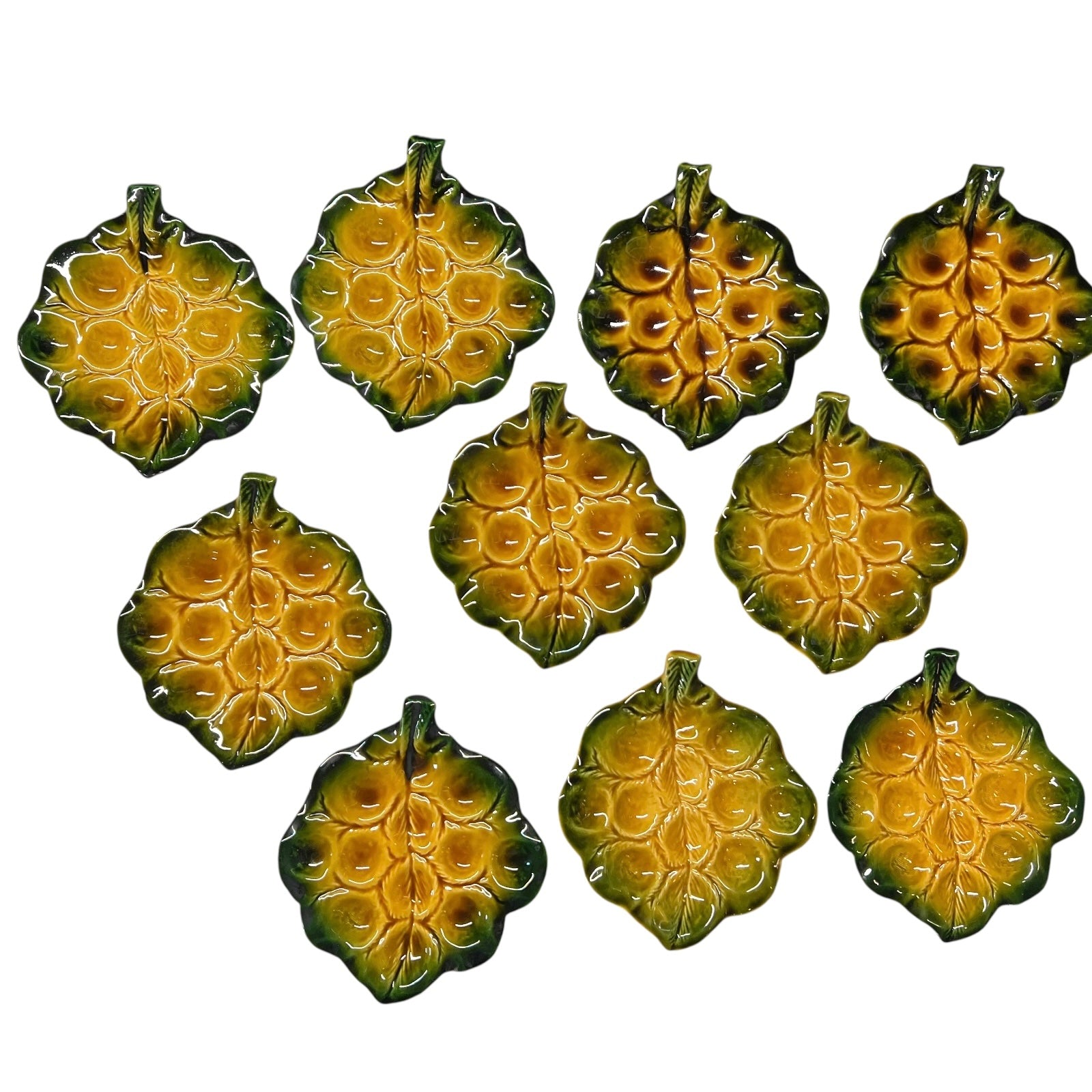 Set of green ceramic leaf-shaped snail escargots plates on a white background