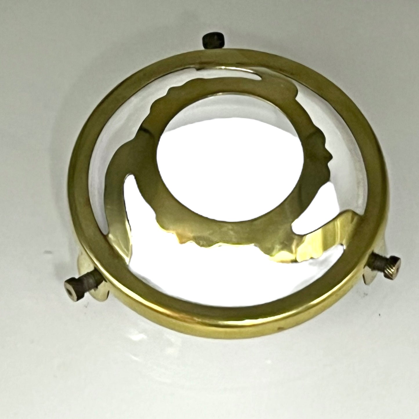 Brass light fitting on a white background