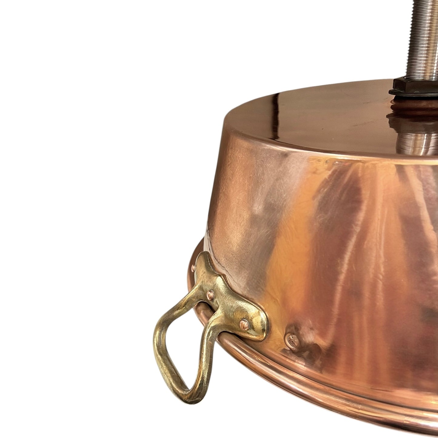Close-up of copper sink with brass pop up waste on a white background
