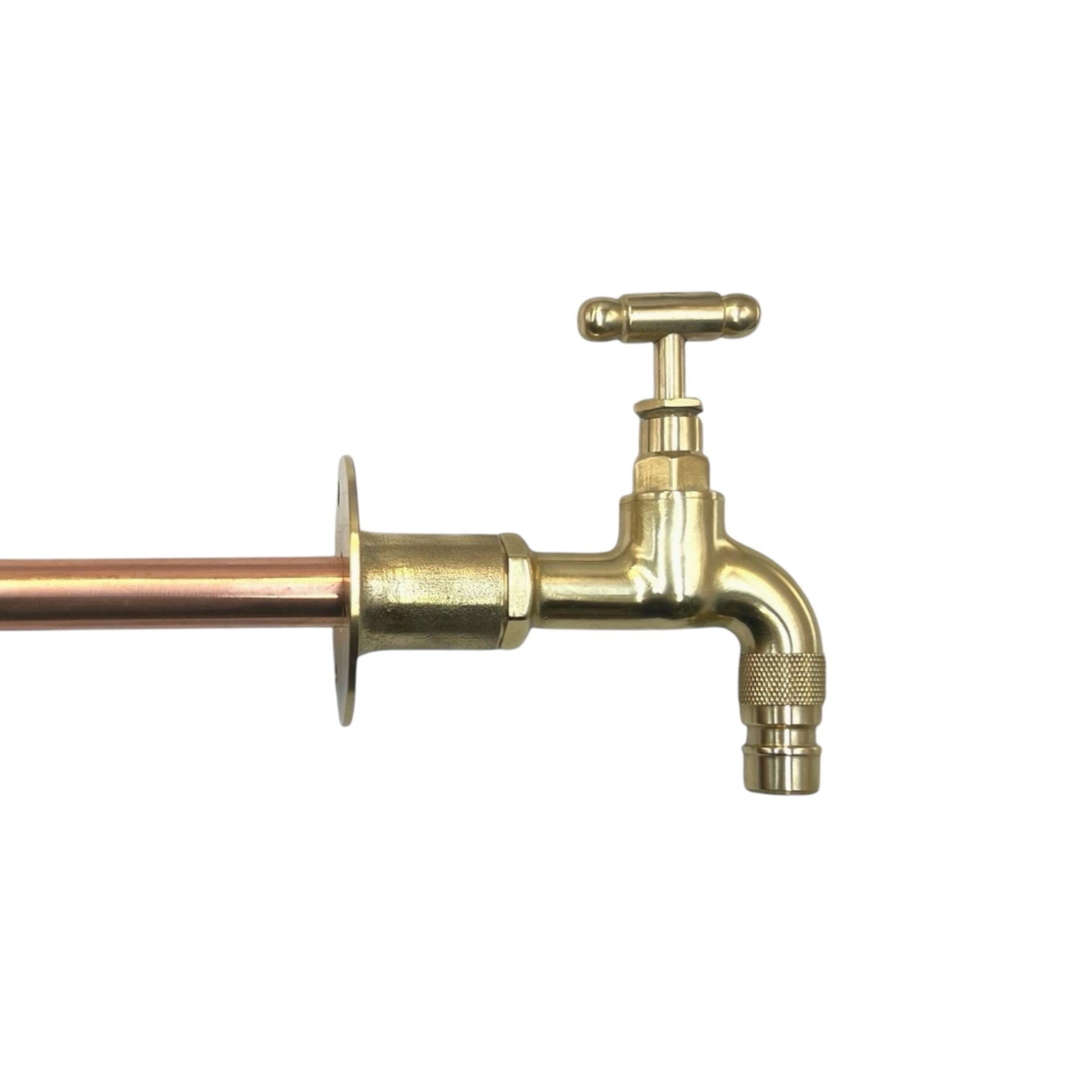 A brass vintage style wall mounted kitchen or bathroom tap with a small head and copper pipework.