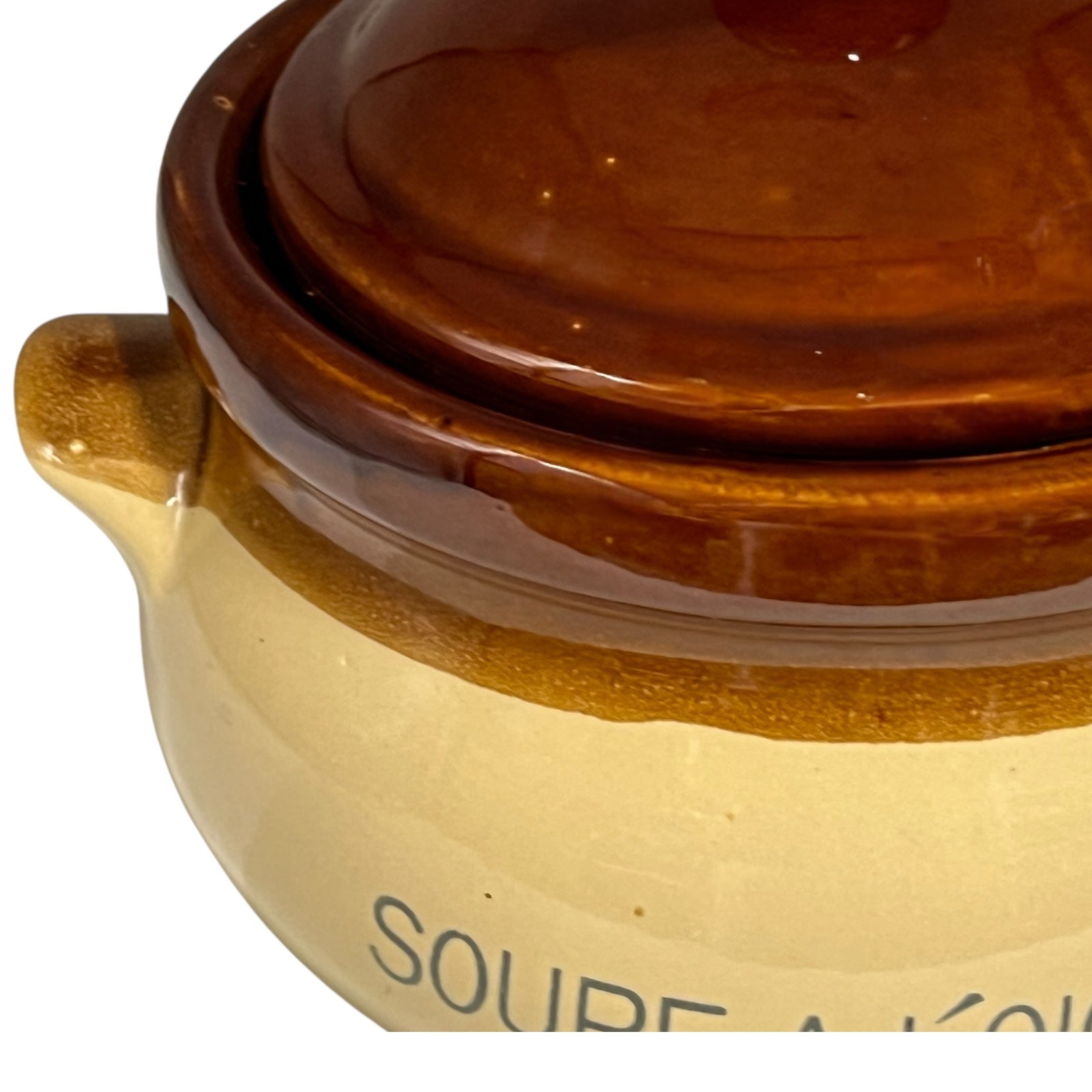 Close-up of a ceramic soup bowl with 'Soupe a L'Oignon' text on a white background