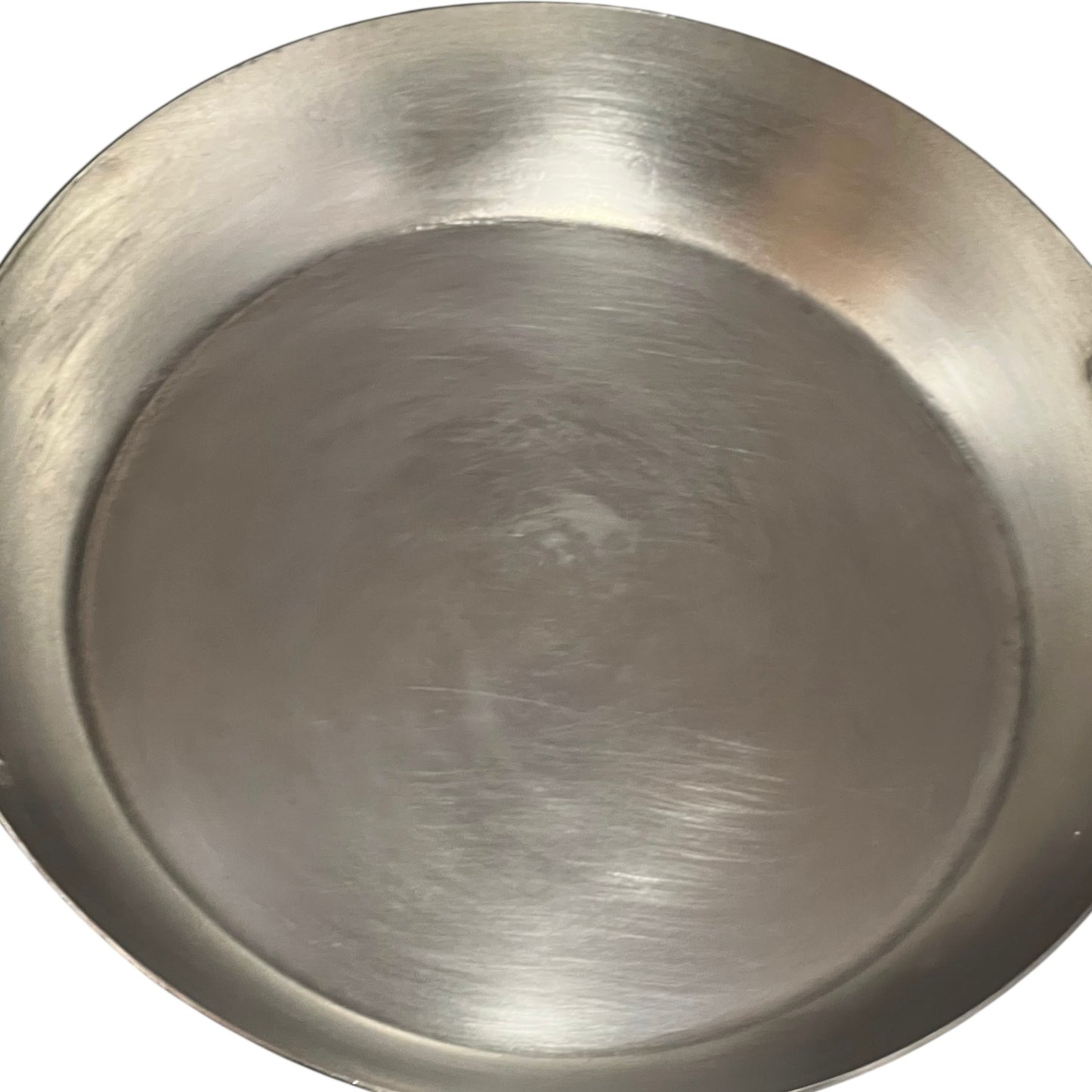 close up of French copper round gratin pan with brass handles and tin lining on a white background