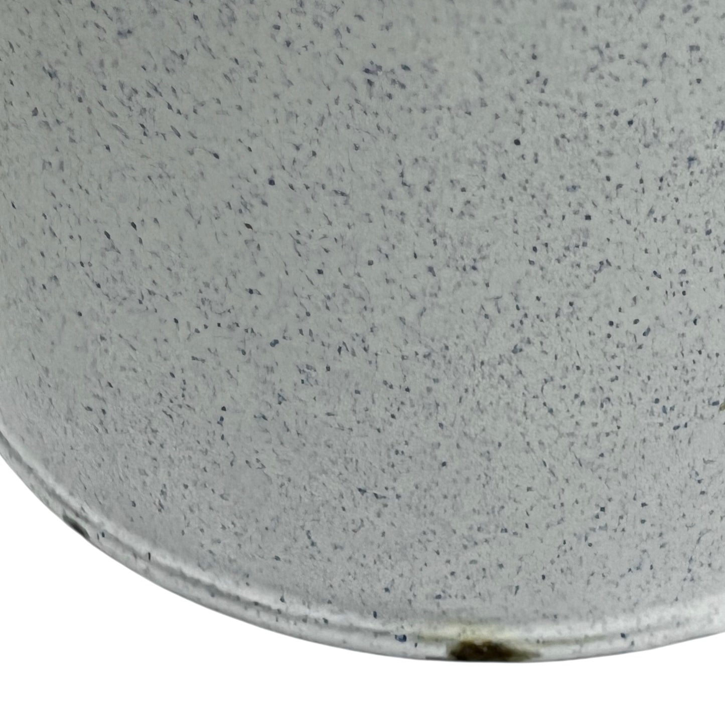 Close-up of a white and blue speckled material surface of a vintage planter