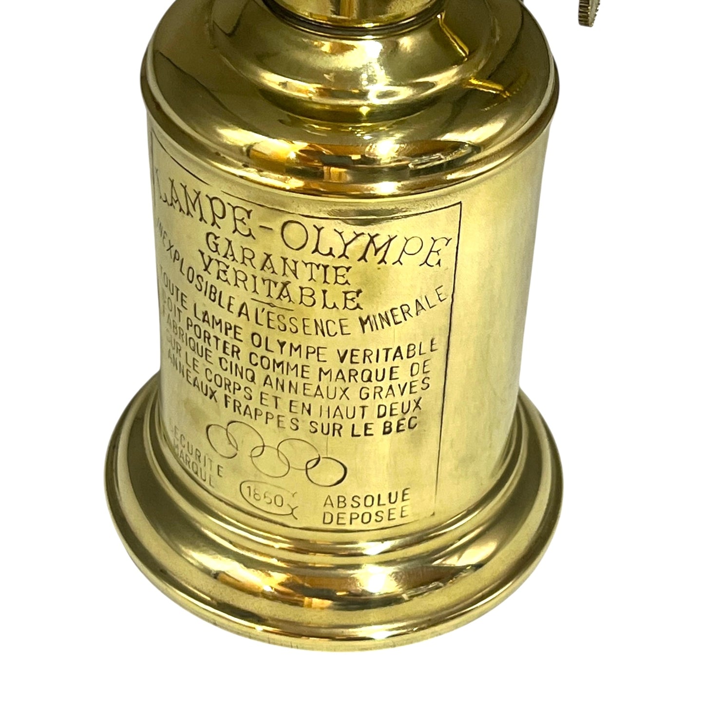 Brass lamp with engraved text on a white background
