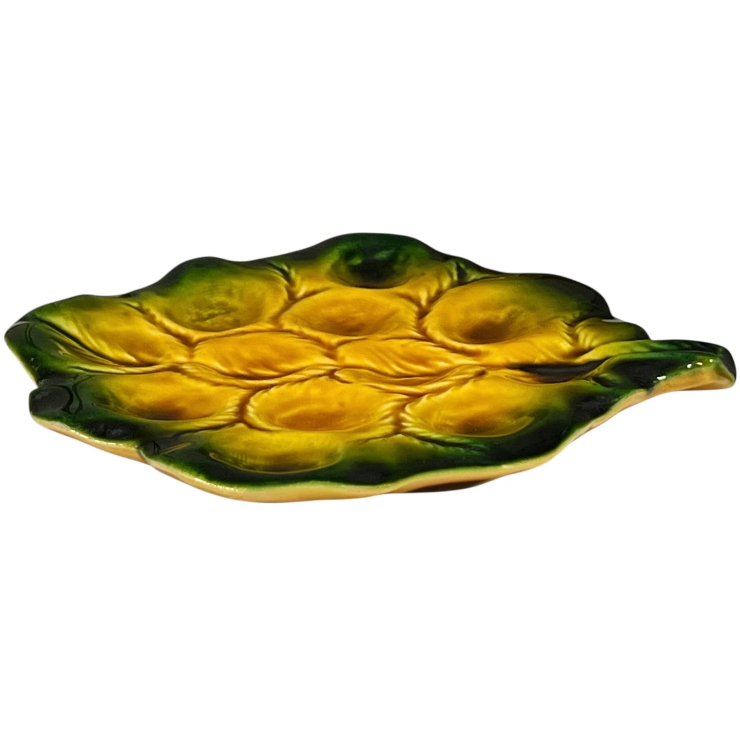 Yellow and green ceramic leaf-shaped snail escargots plate on a white background