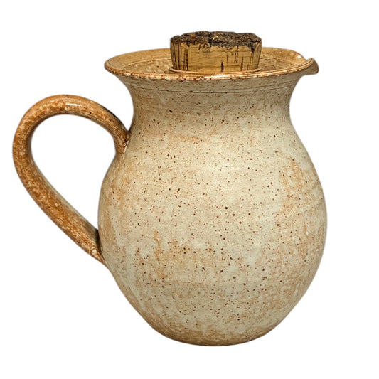 Ceramic pitcher with a handle on a white background