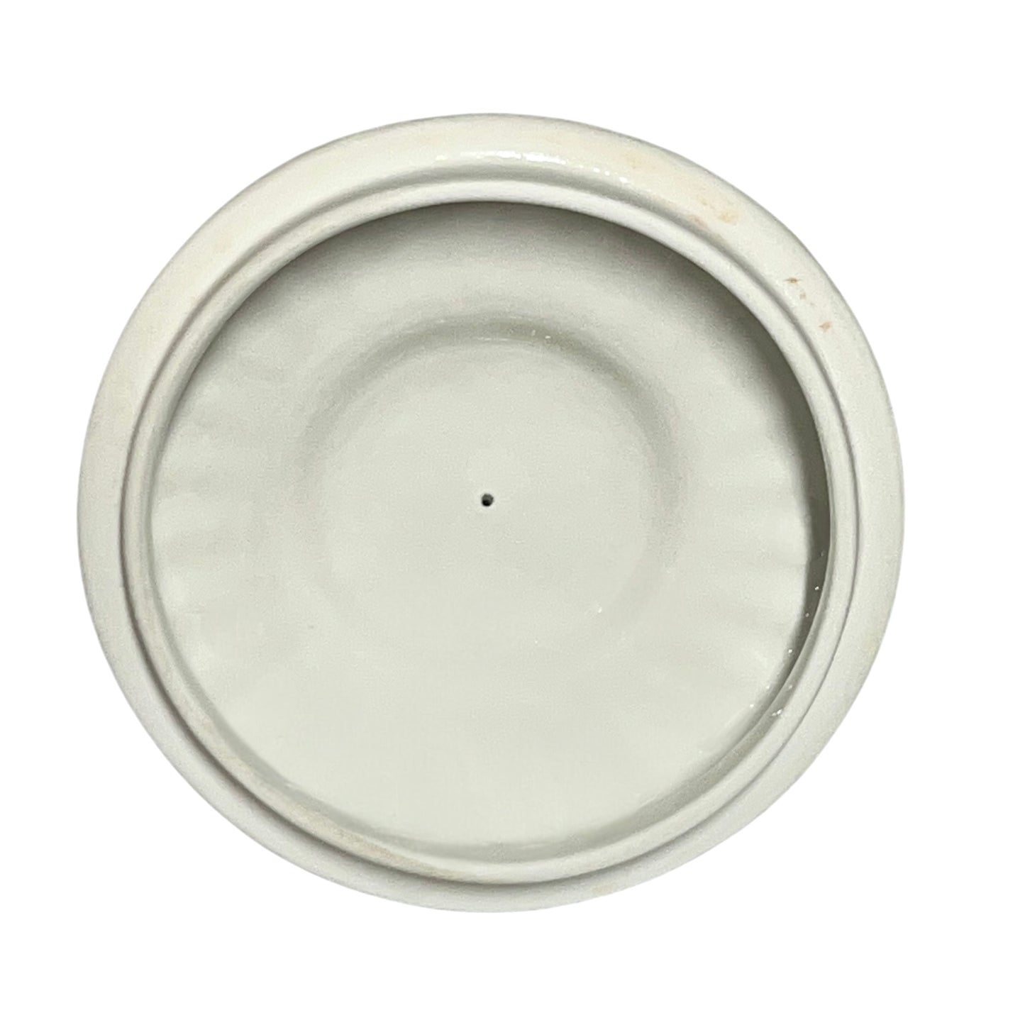 Round ceramic lid with a white glaze on a white background