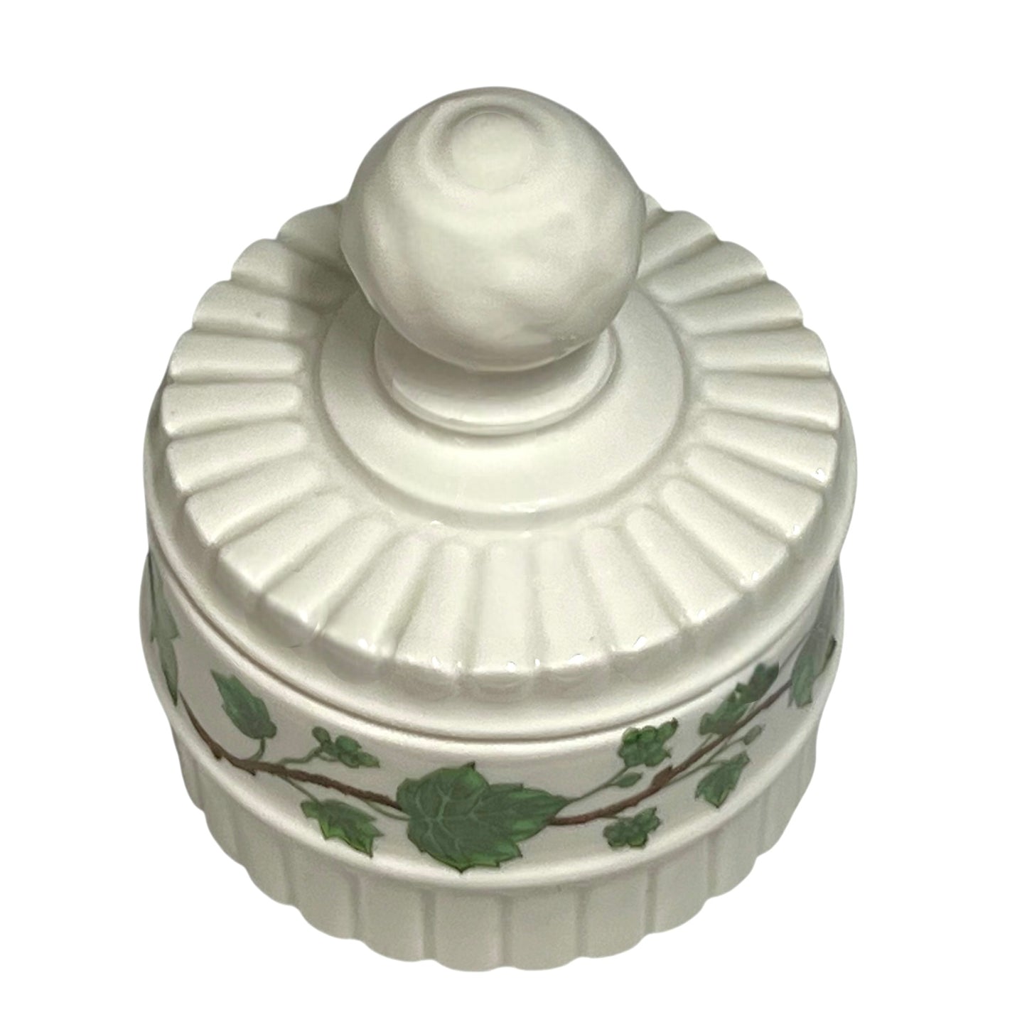 White ceramic jar with decorative lid and leaf pattern on a white background