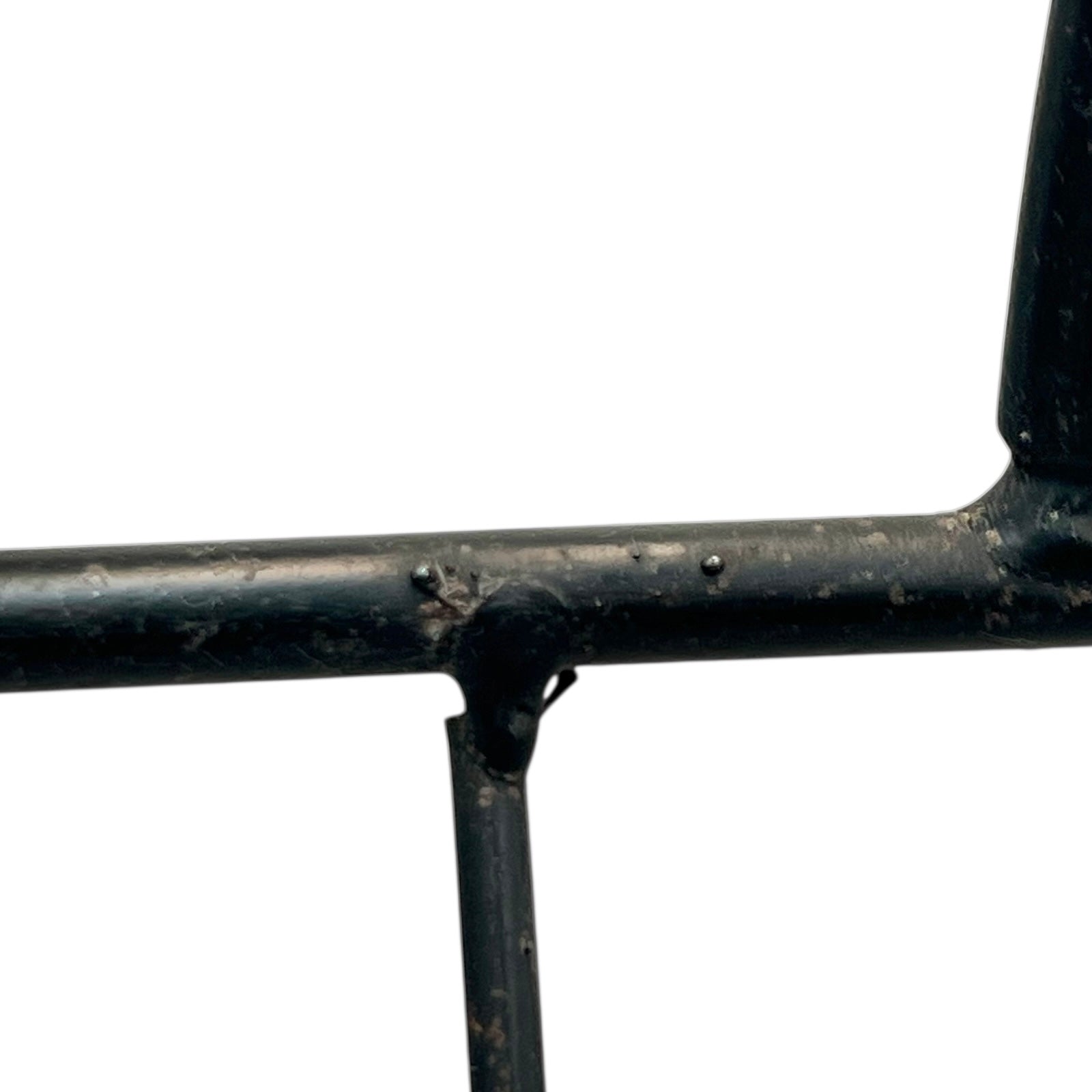 Close-up of a black metal stand on a white background