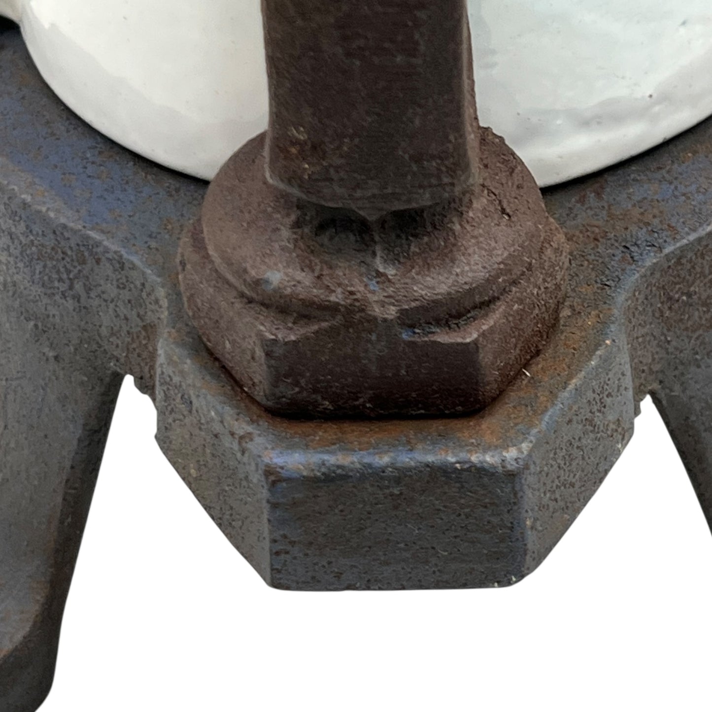 Close-up of a metal base with a hexagonal nut on a white background