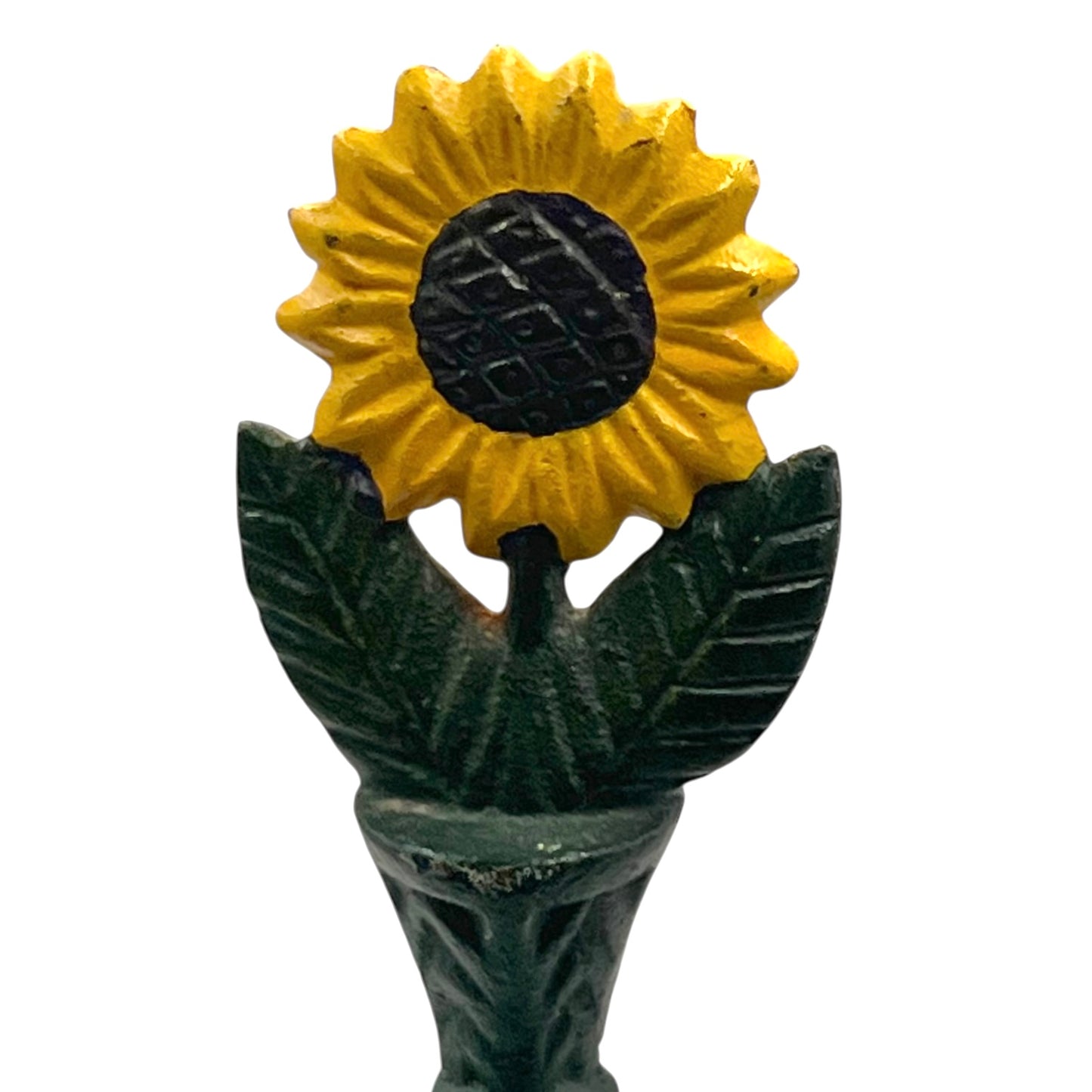 Decorative sunflower top with yellow petals and green leaves sitting on a kitchen roll holder on a white background