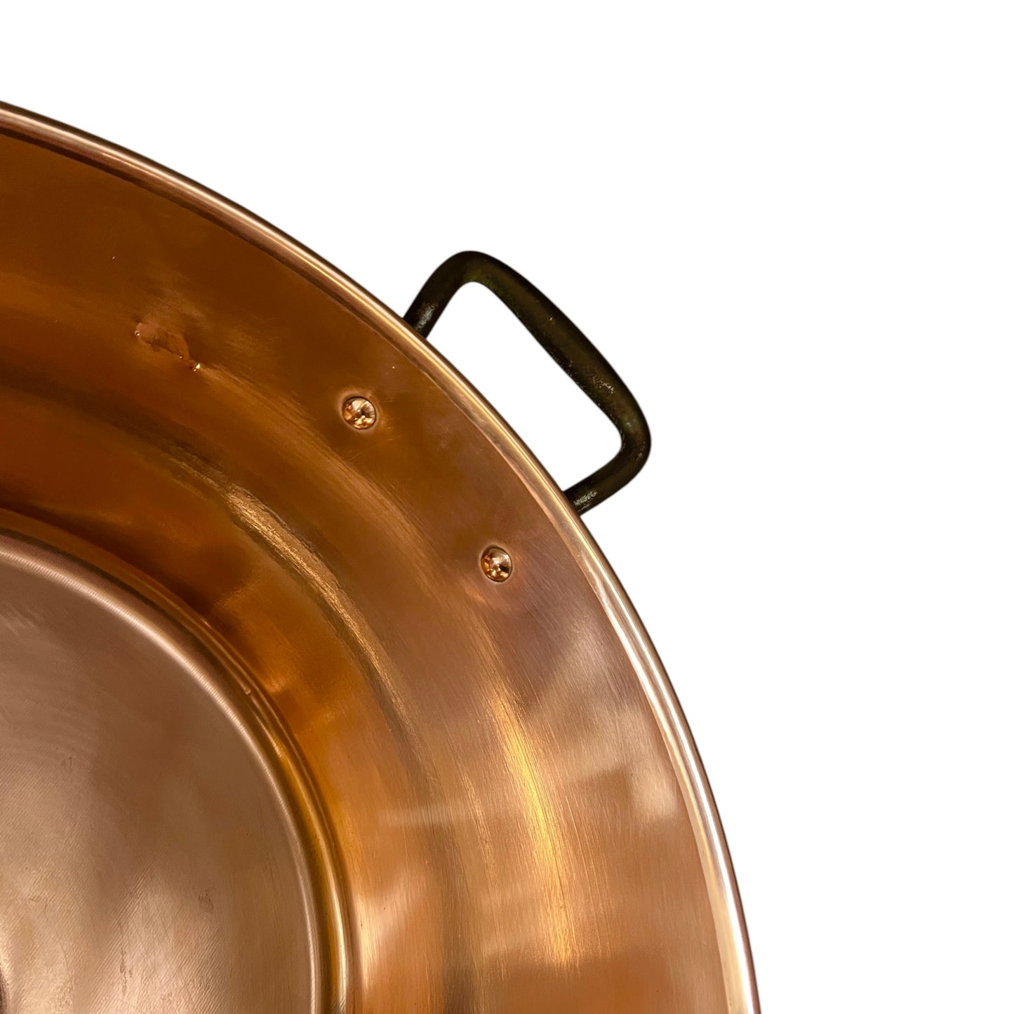 Close up of French copper bowl upcycled into a copper sink with iron handles and a chrome pop up waste on a white background
