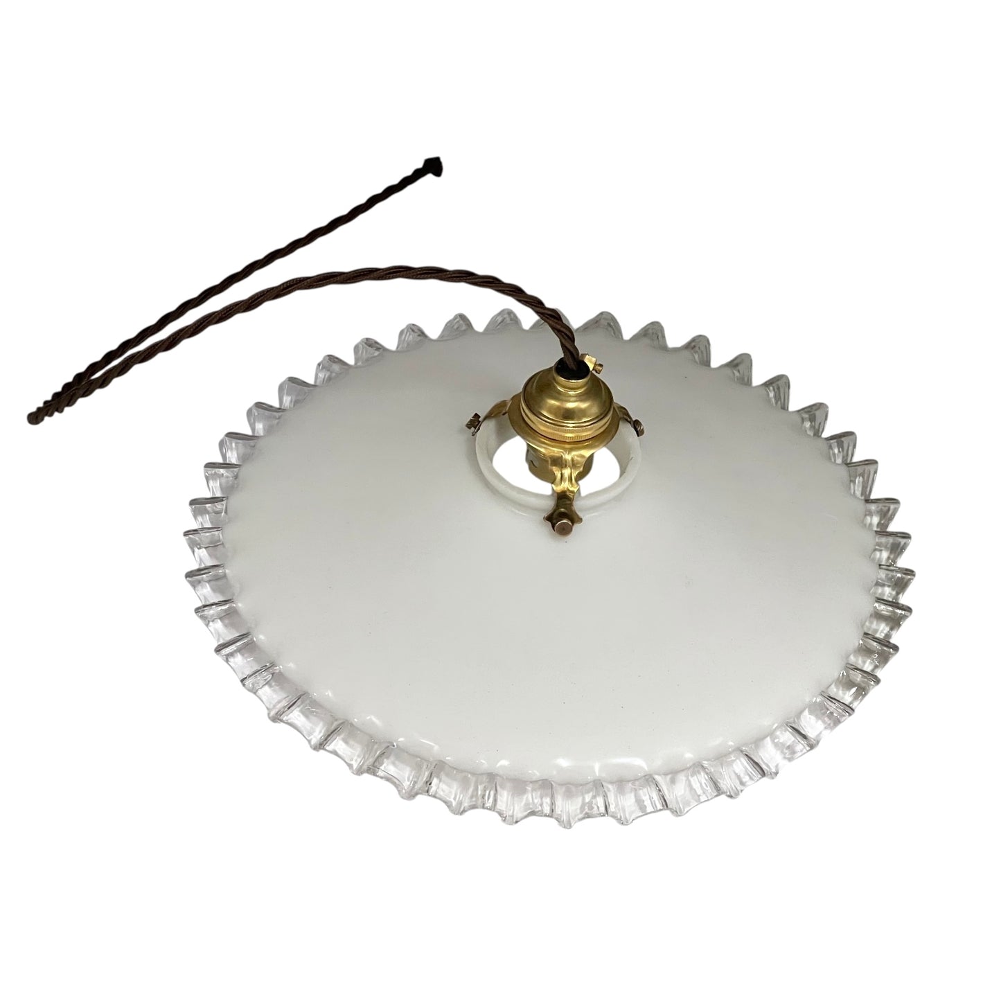 Close-up of a pendant light with white glass shade and brass fitting on a white background
