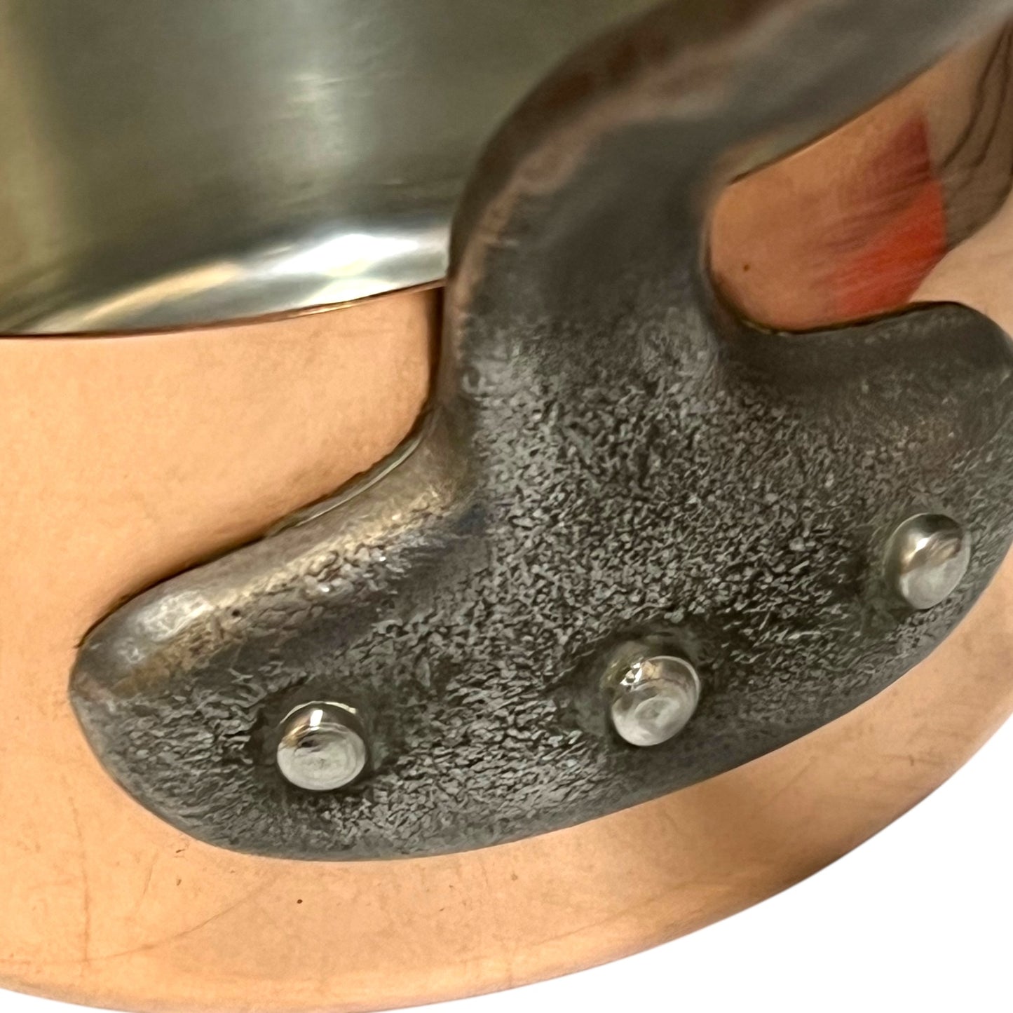 cast iron handle of copper pan
