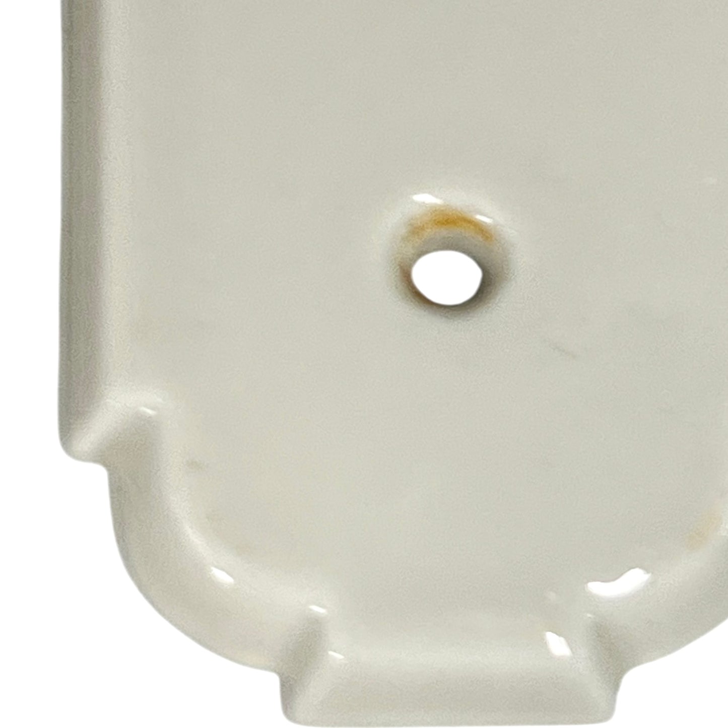 Close up of fingerplate with vintage car illustrations on a white background