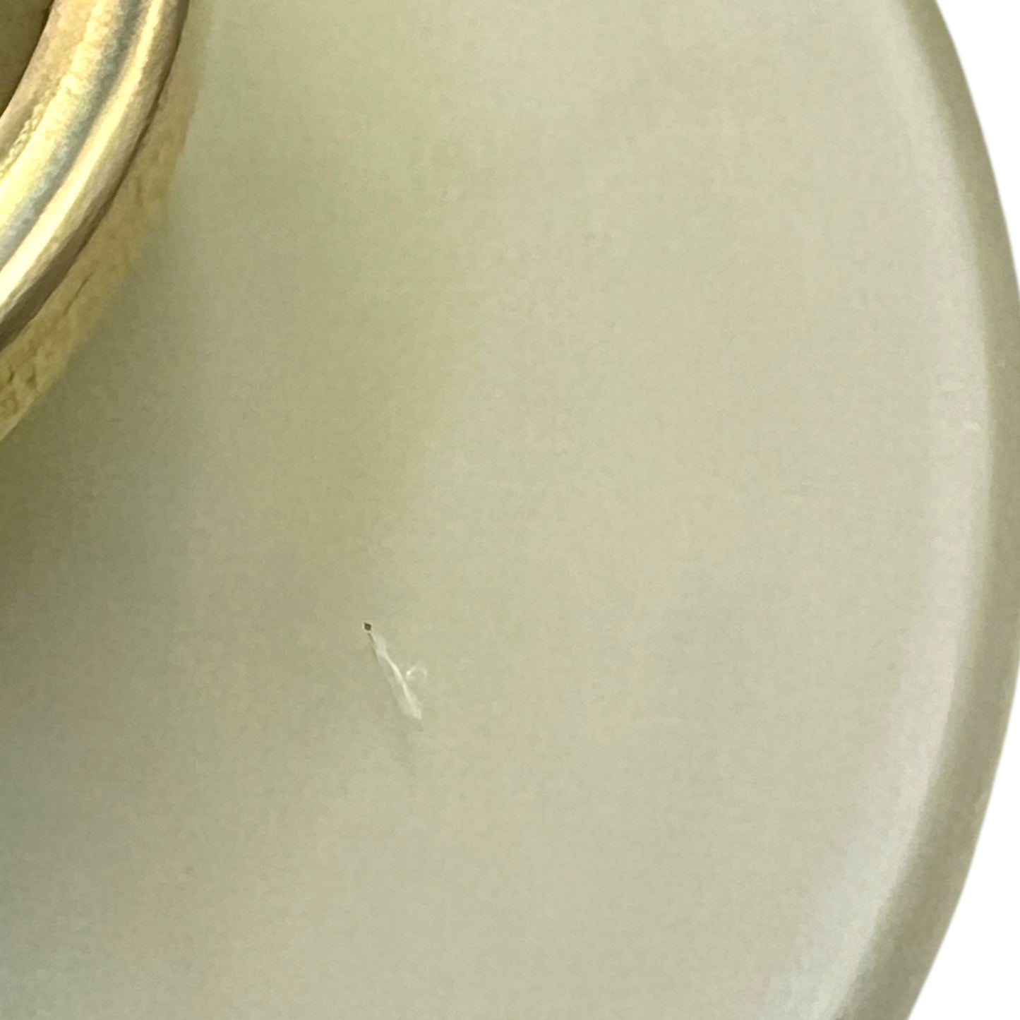 Close-up of a milk glass shade on a white background