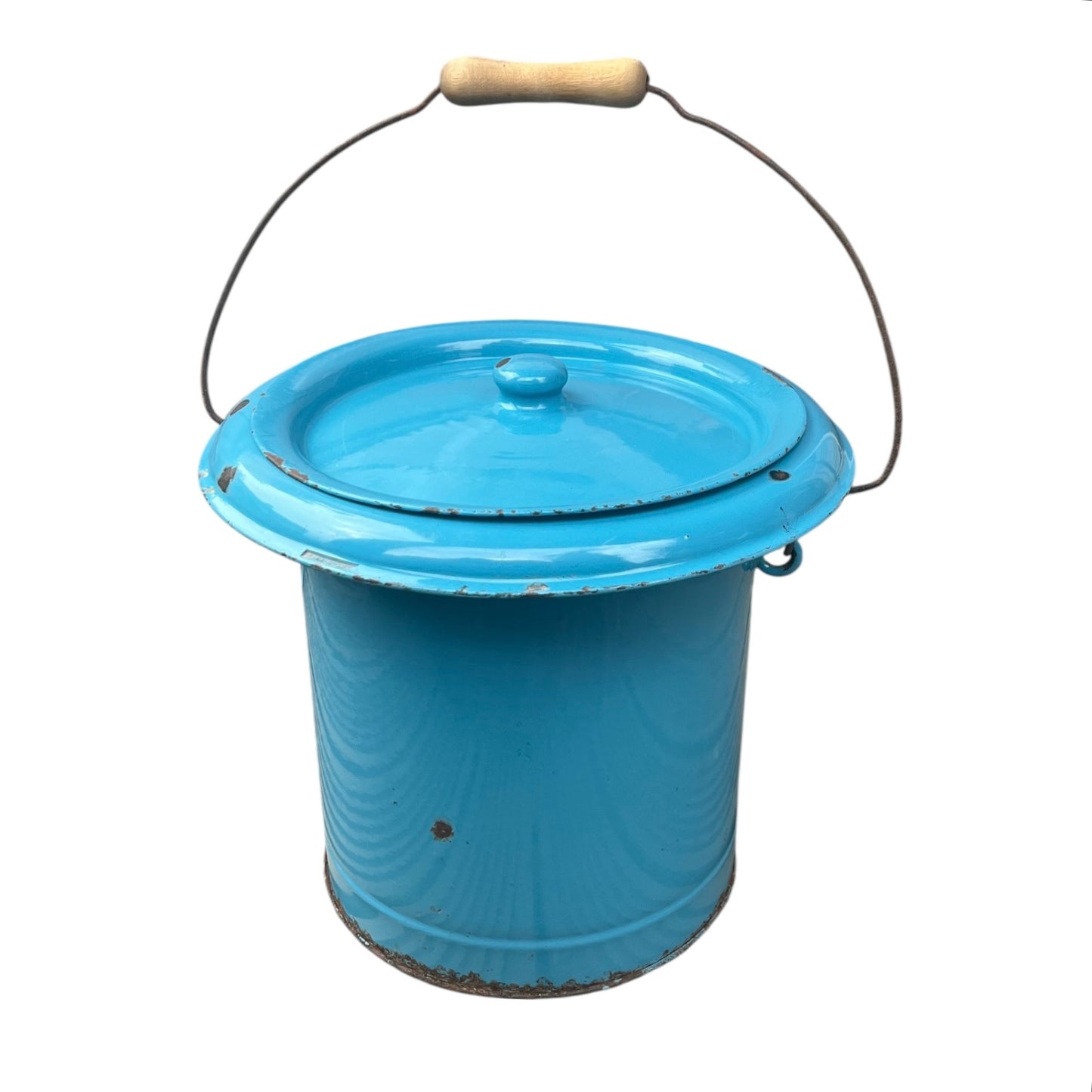 Blue metal bucket with a wooden handle on a white background