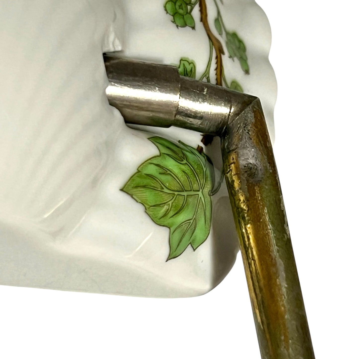 close up of towel hoop with leaf design on a white background
