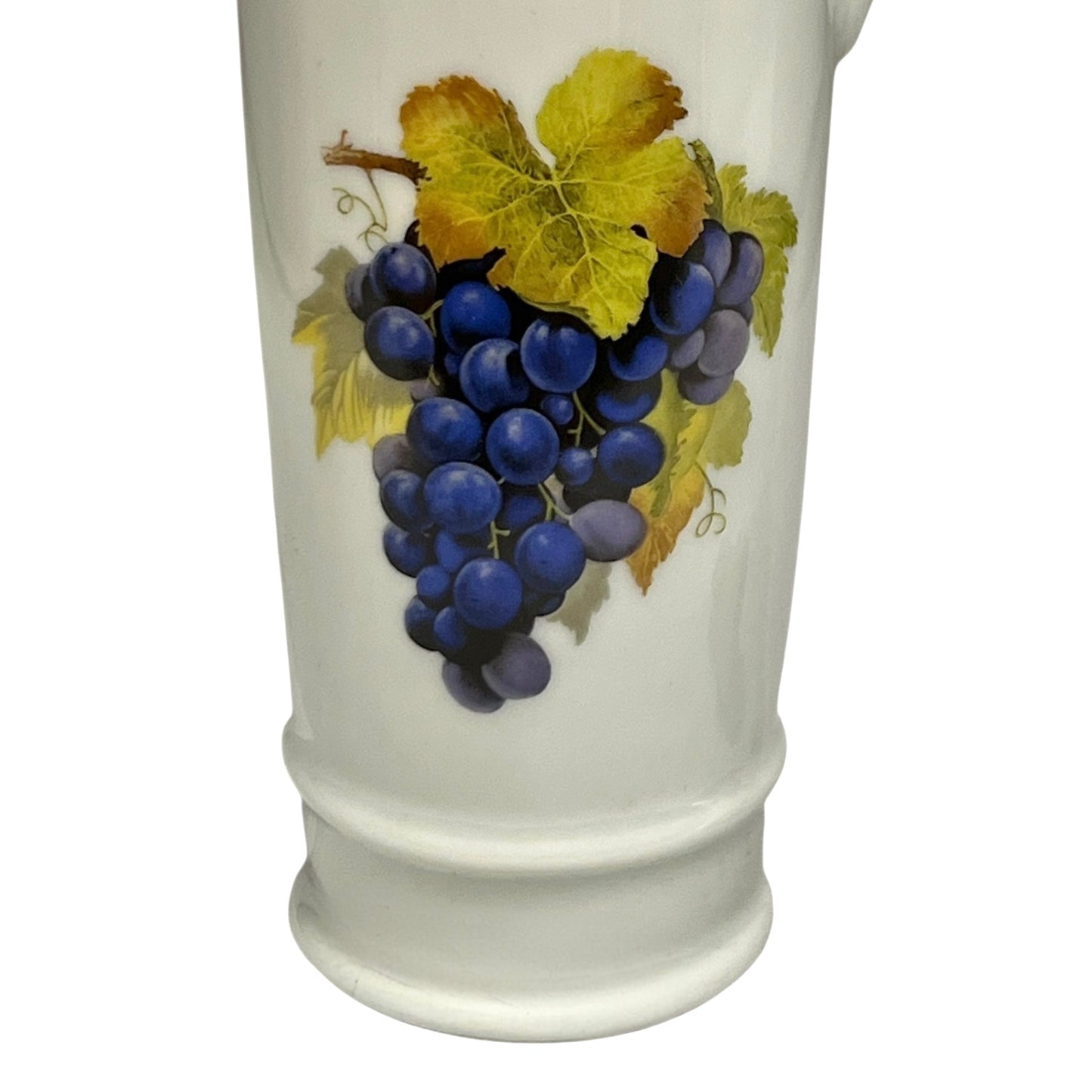 White decanter with a design of blue grapes and yellow leaves on a white background