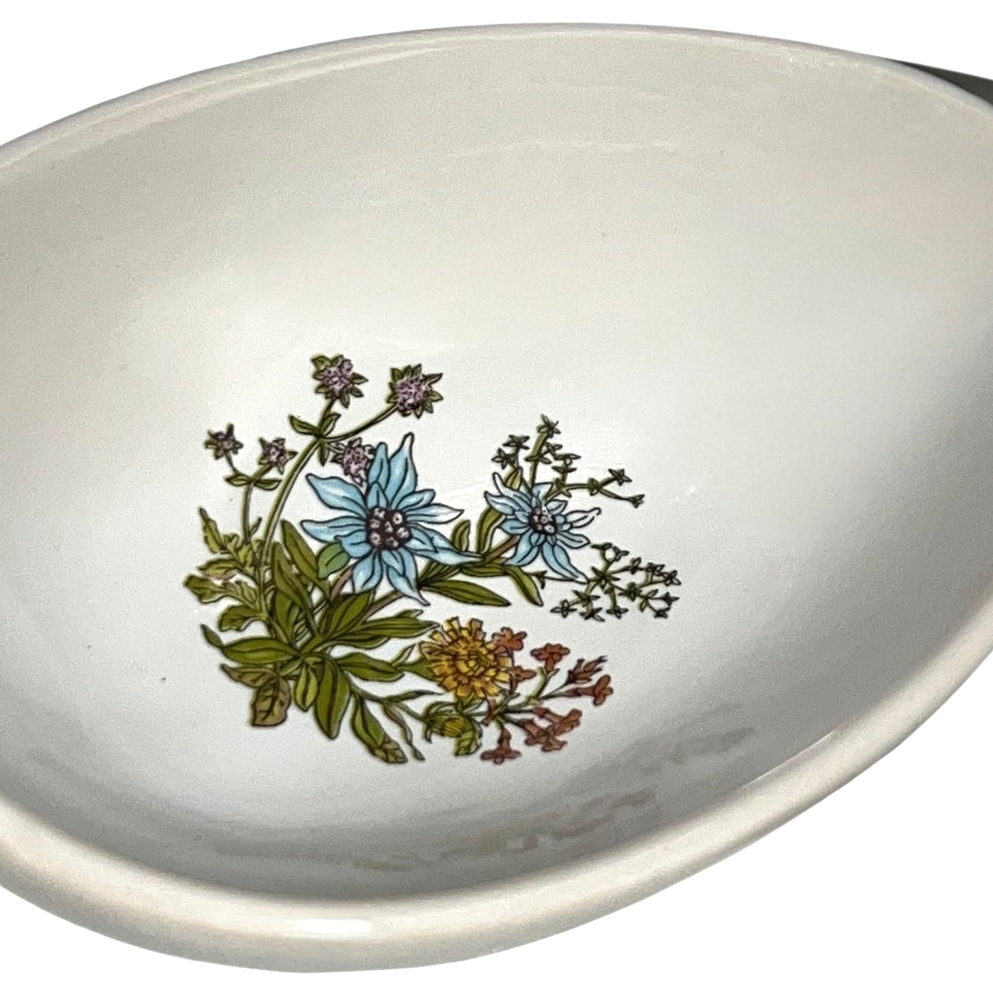 White ceramic bowl with floral design on a white background