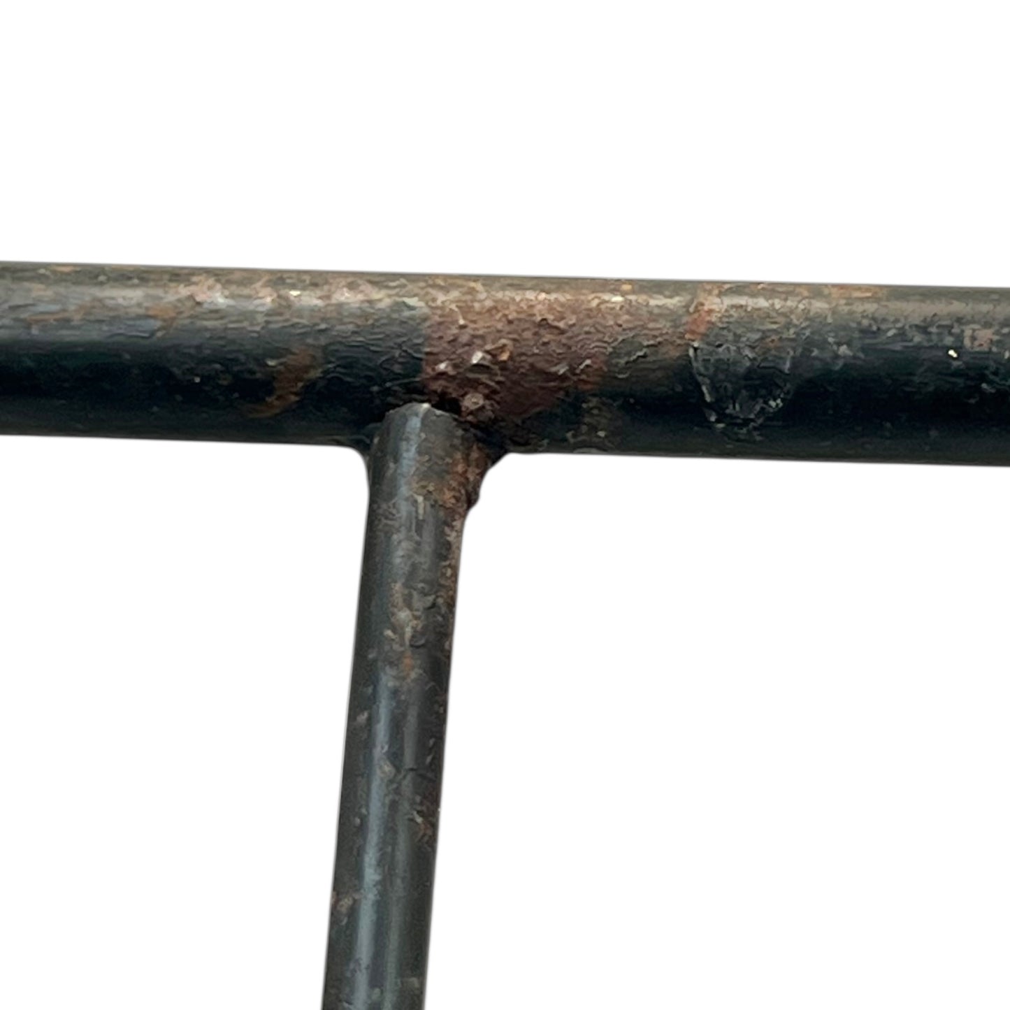 Close-up of a black metal stand on a white background