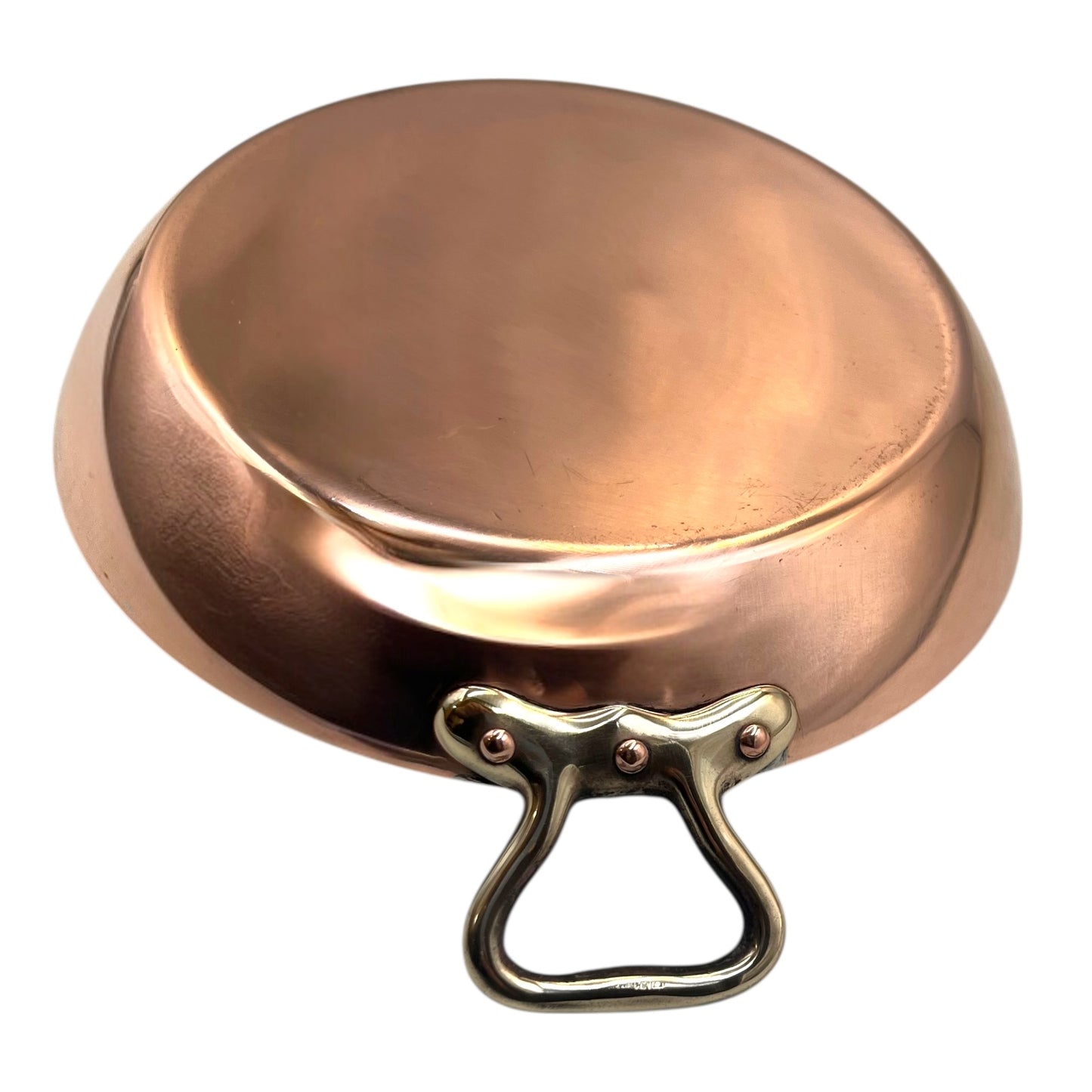 French copper round gratin pan with brass handles on a white background