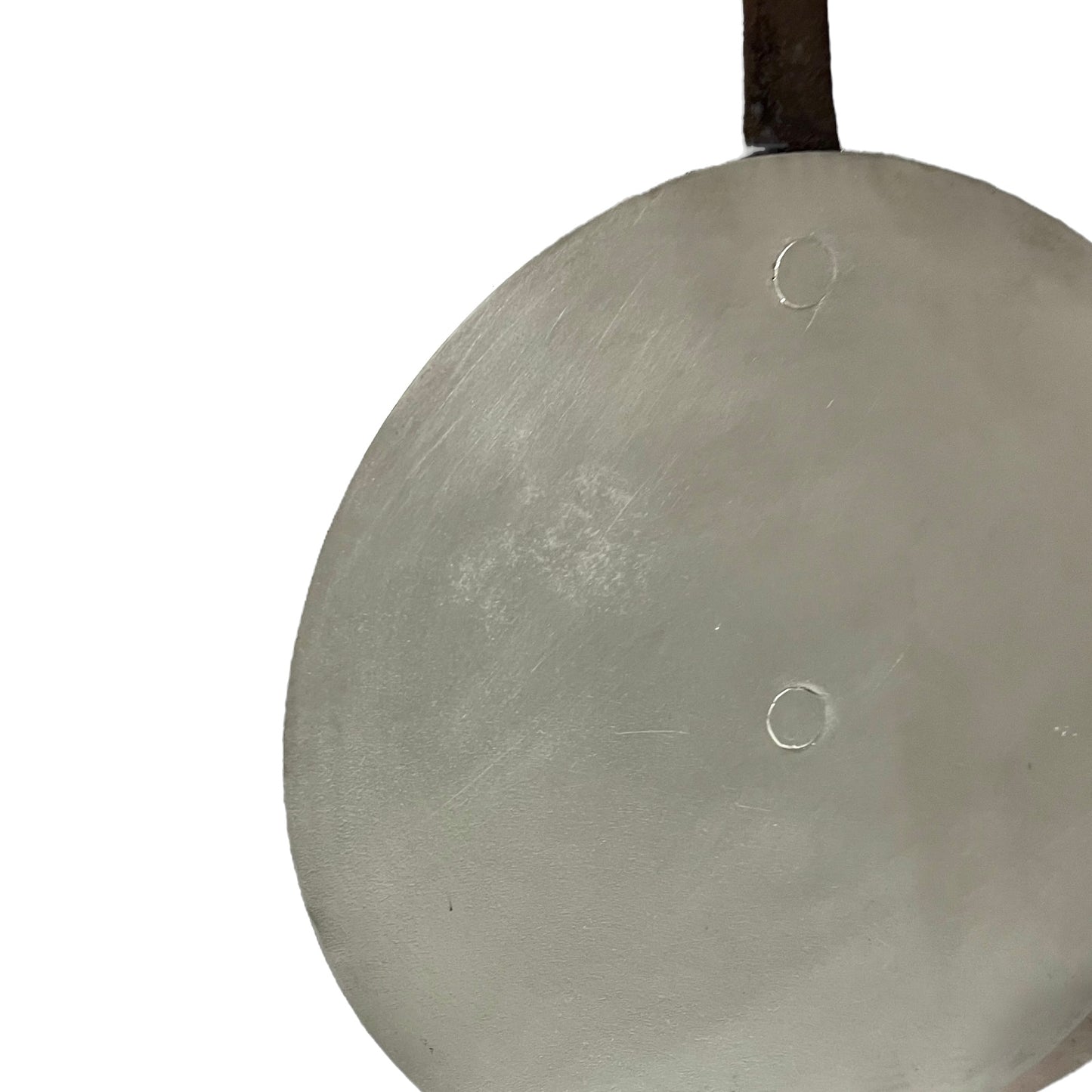 Close up French copper pan lid showing hand wiped traditional new tin lining on a white background