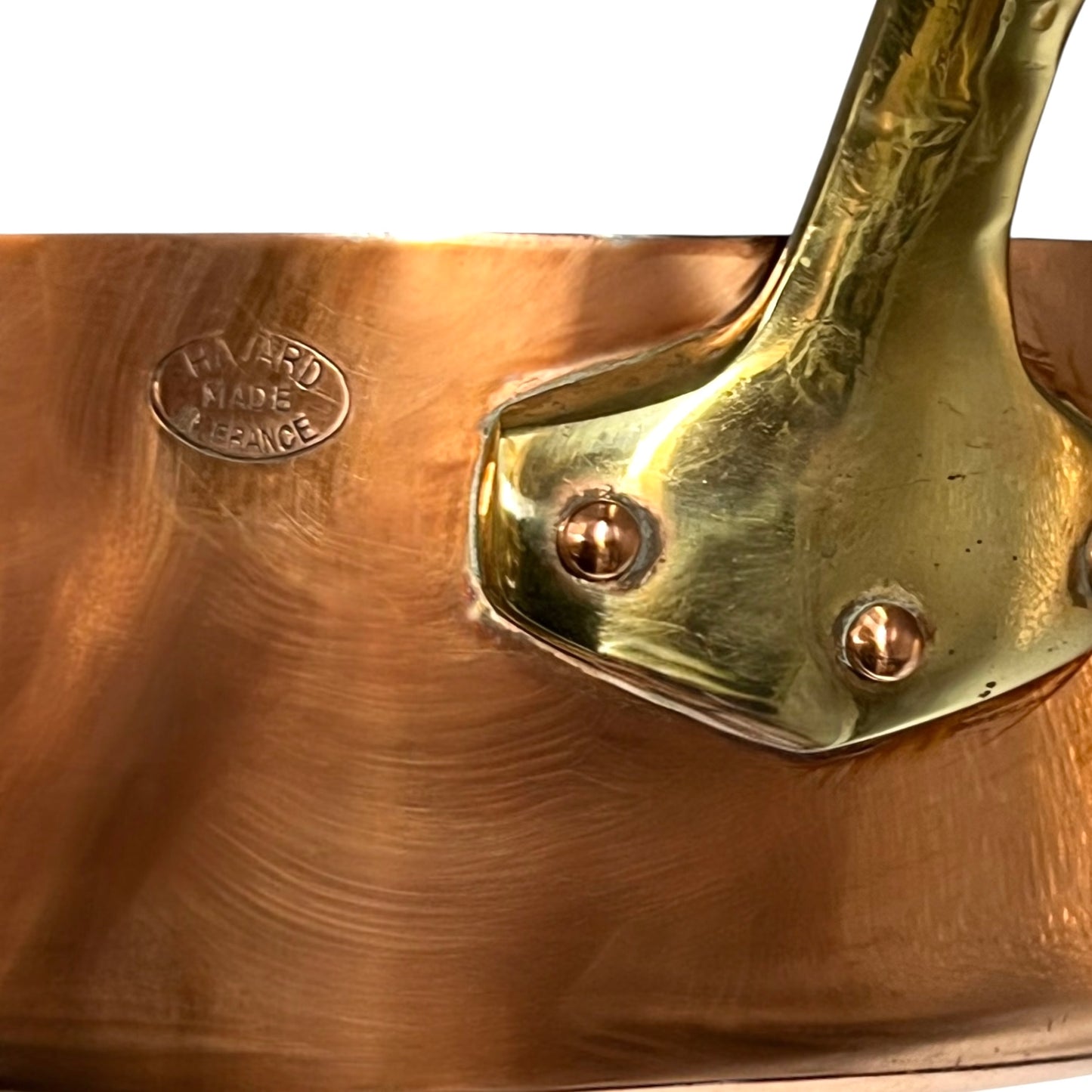 Close-up of a copper pot with brass handle and 'Havard' branding.