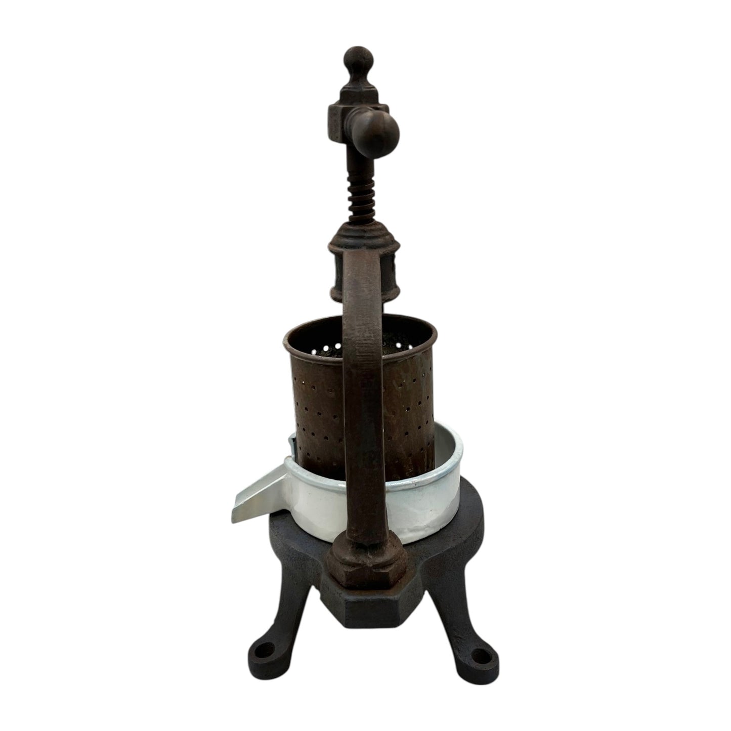 Vintage French cast iron metal fruit press with a white enamel container on a white background