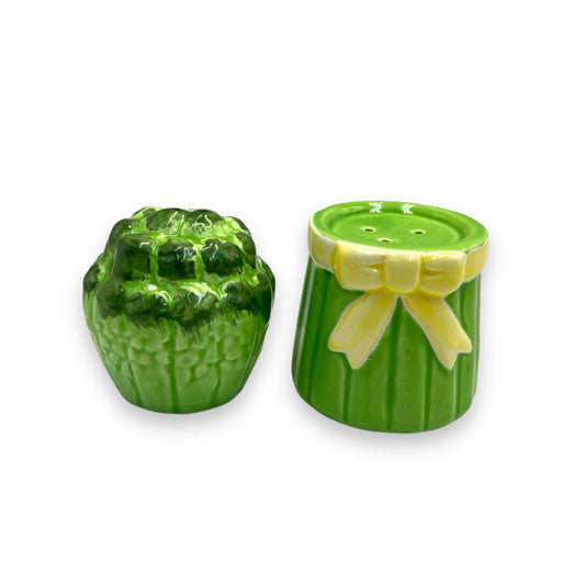 A set of two French ceramic salt and pepper pots shaped like asparagus, with green and yellow colors.