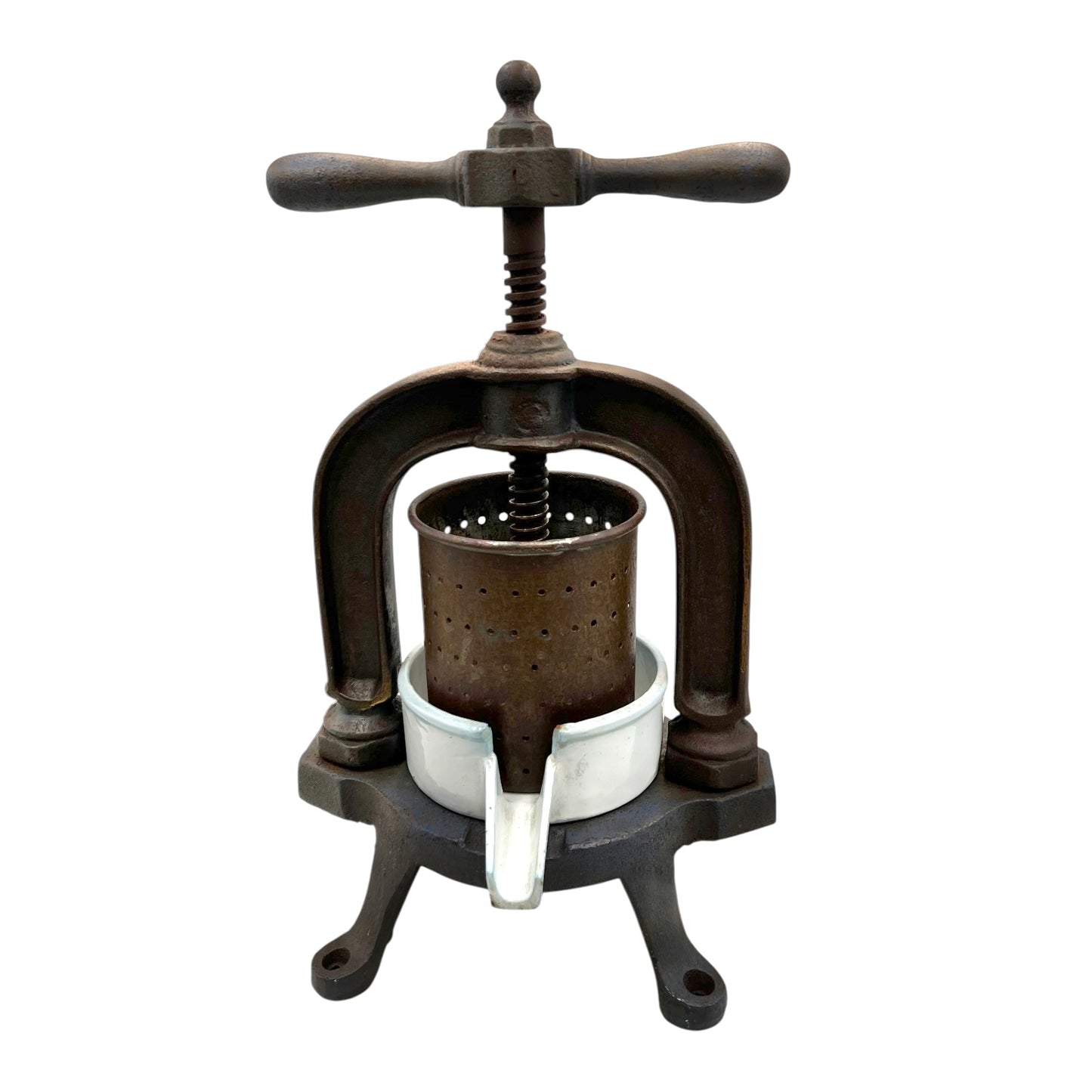 Vintage French cast iron metal fruit press with a white enamel container on a white background