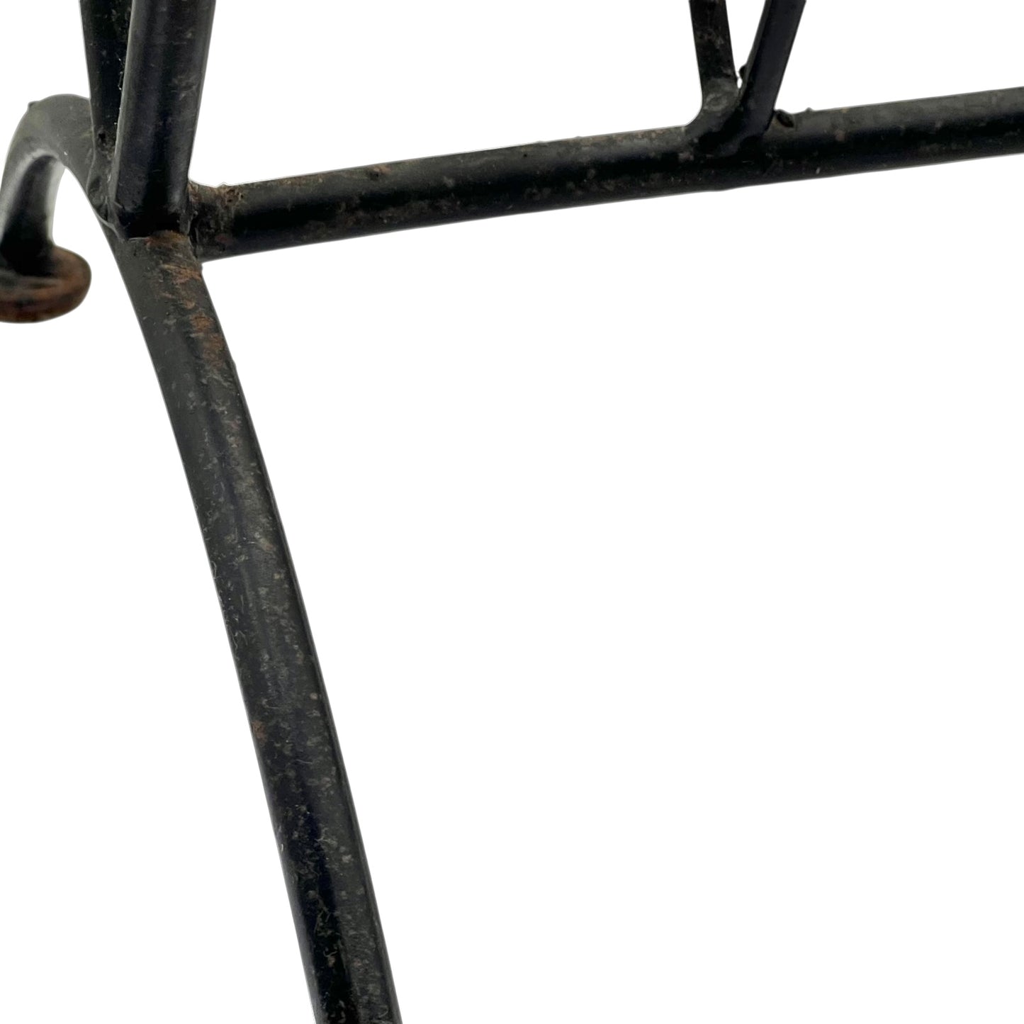 Close-up of a black metal stand on a white background