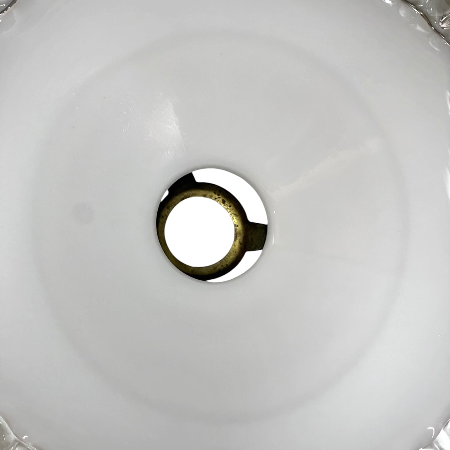 Close-up of a round metallic object on a white background