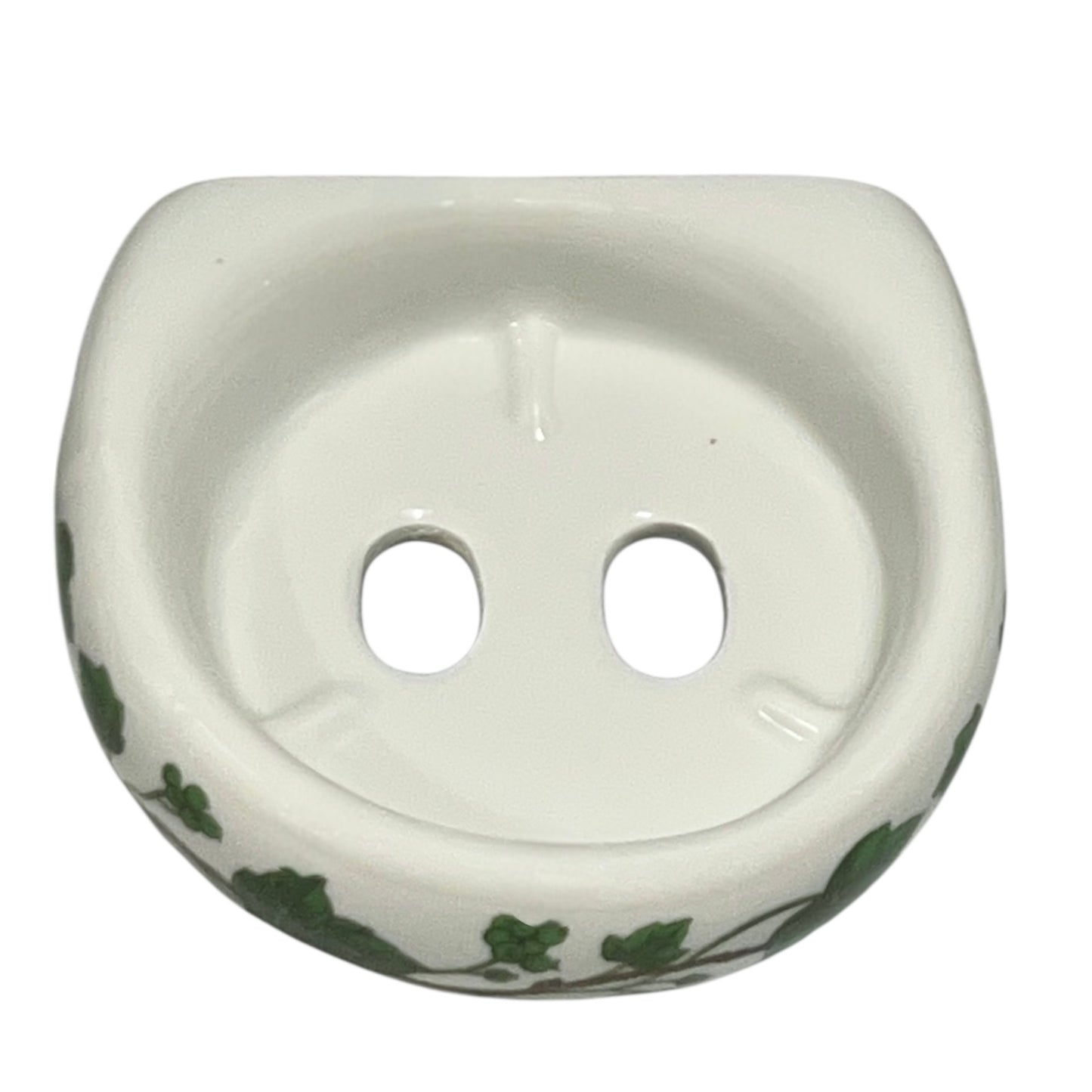 Porcelain bathroom toothbrush holder featuring green leaf patterns on a white background