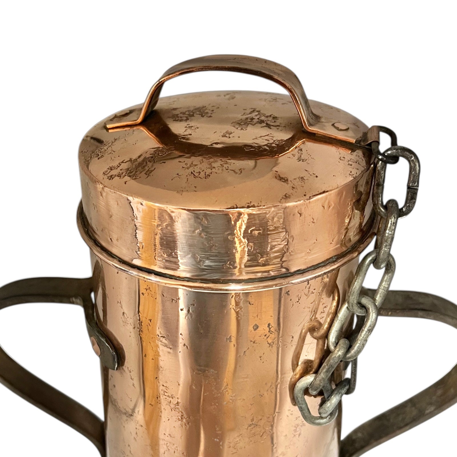 Close-up of a copper milk churn with a chain handle on a white background